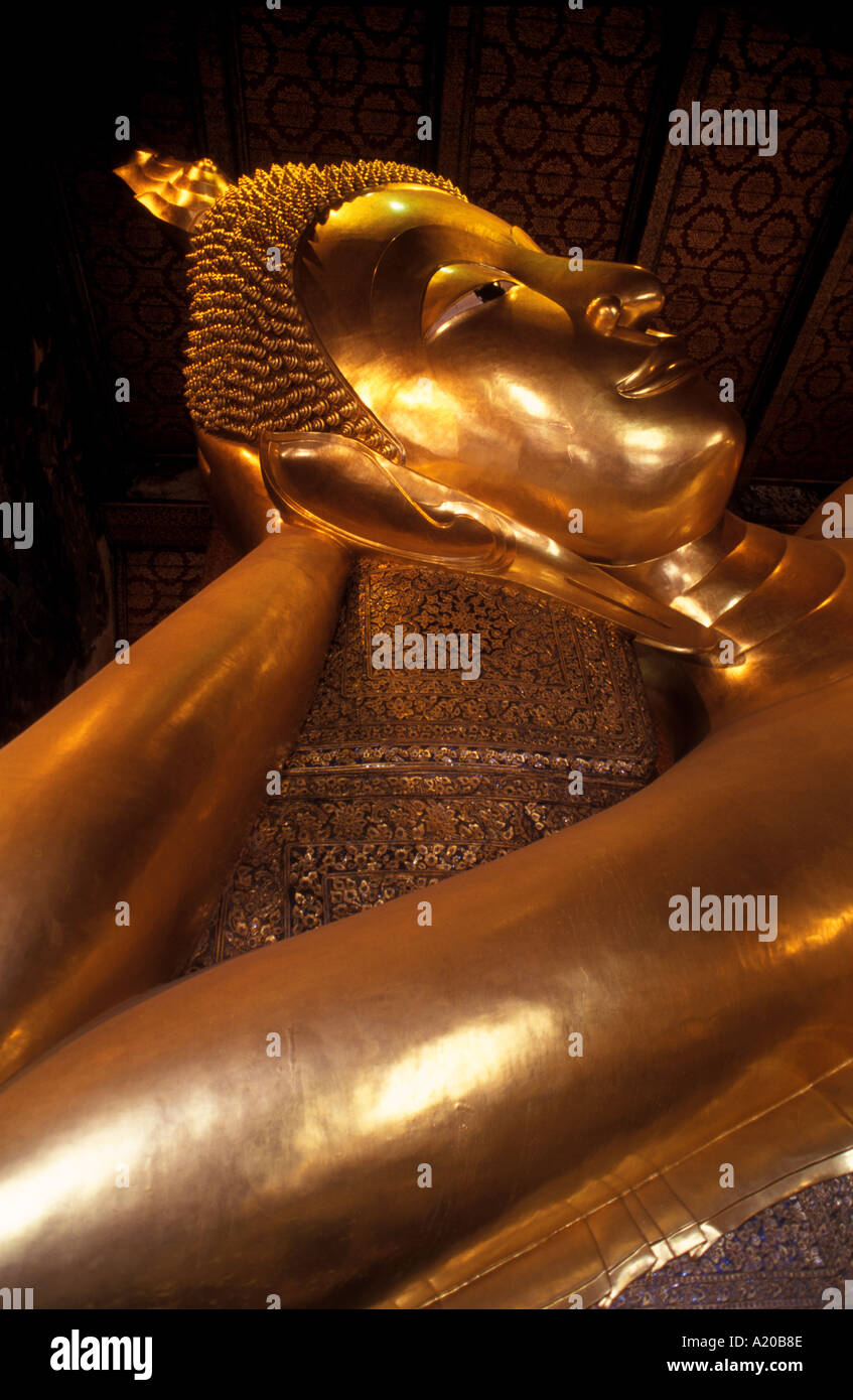 Reclining Buddha at Wat Po Bangkok Thailand The statue conveys the Buddha entering Nirvana a common motif in Buddhist iconogra Stock Photo