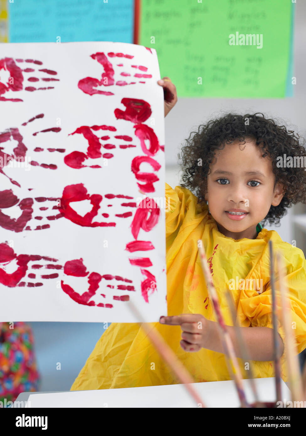 Girl presenting her finger painting in art class Stock Photo Alamy