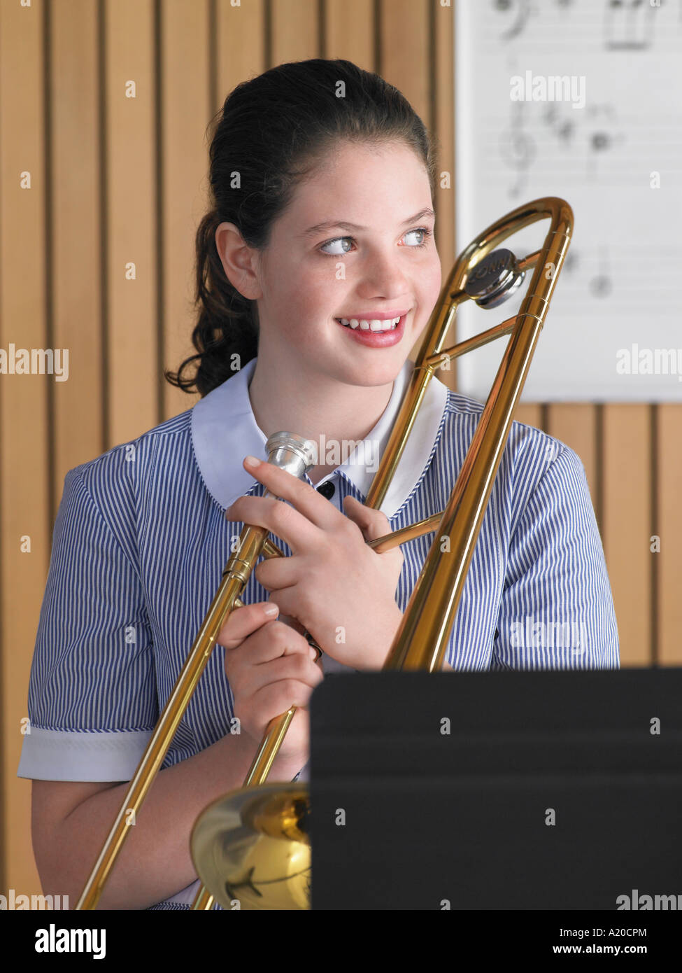 Trombone Class High school girl holding trombone in class, portrait Stock Photo - Alamy