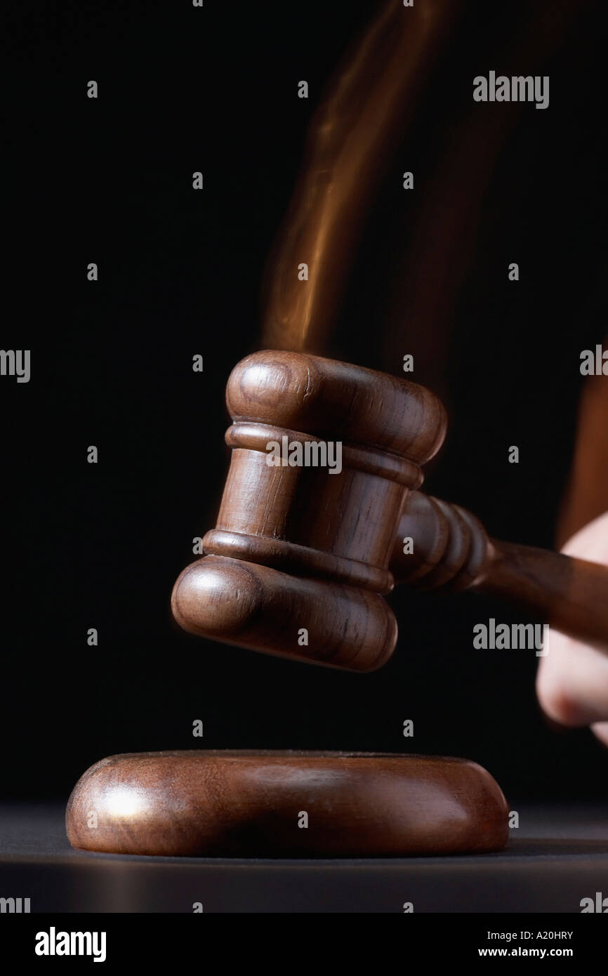 Gavel hitting base, black background Stock Photo Alamy
