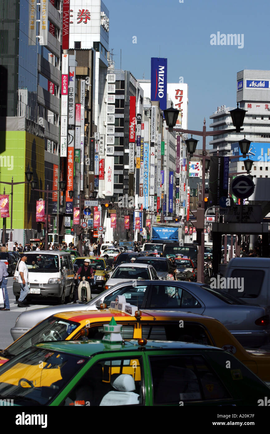 Busy street with traffic and advertising, in Ginza, Tokyo, Japan Stock Photo