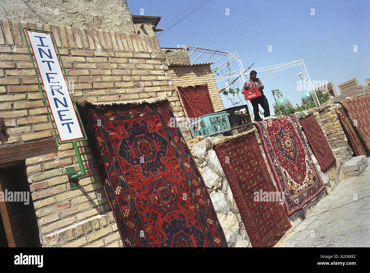 A carpet trader shop with internet access in the Old Silk Road trading route city of Bukhara, Uzbekistan, CIS Stock Photo