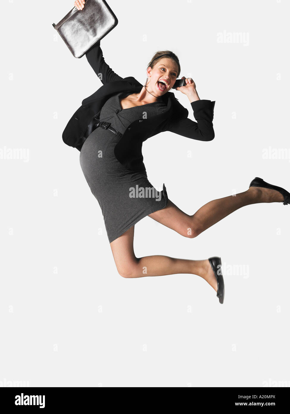 Pregnant Businesswoman on cell phone jumping, mid air Stock Photo - Alamy