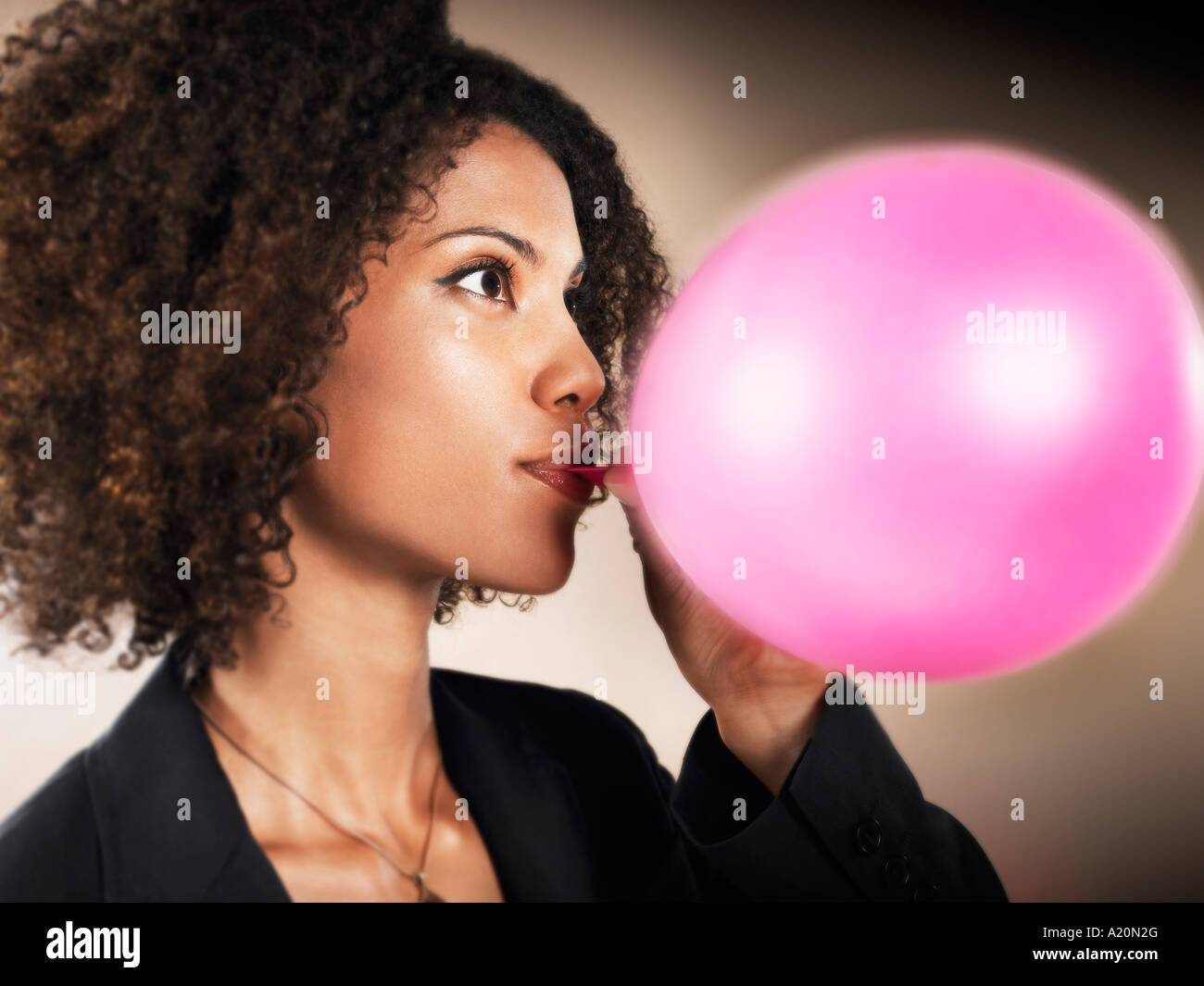 Businesswoman Blowing up Balloon Stock Photo