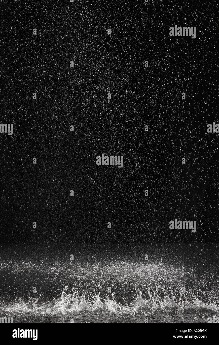 Dark background shot of rain falling Stock Photo