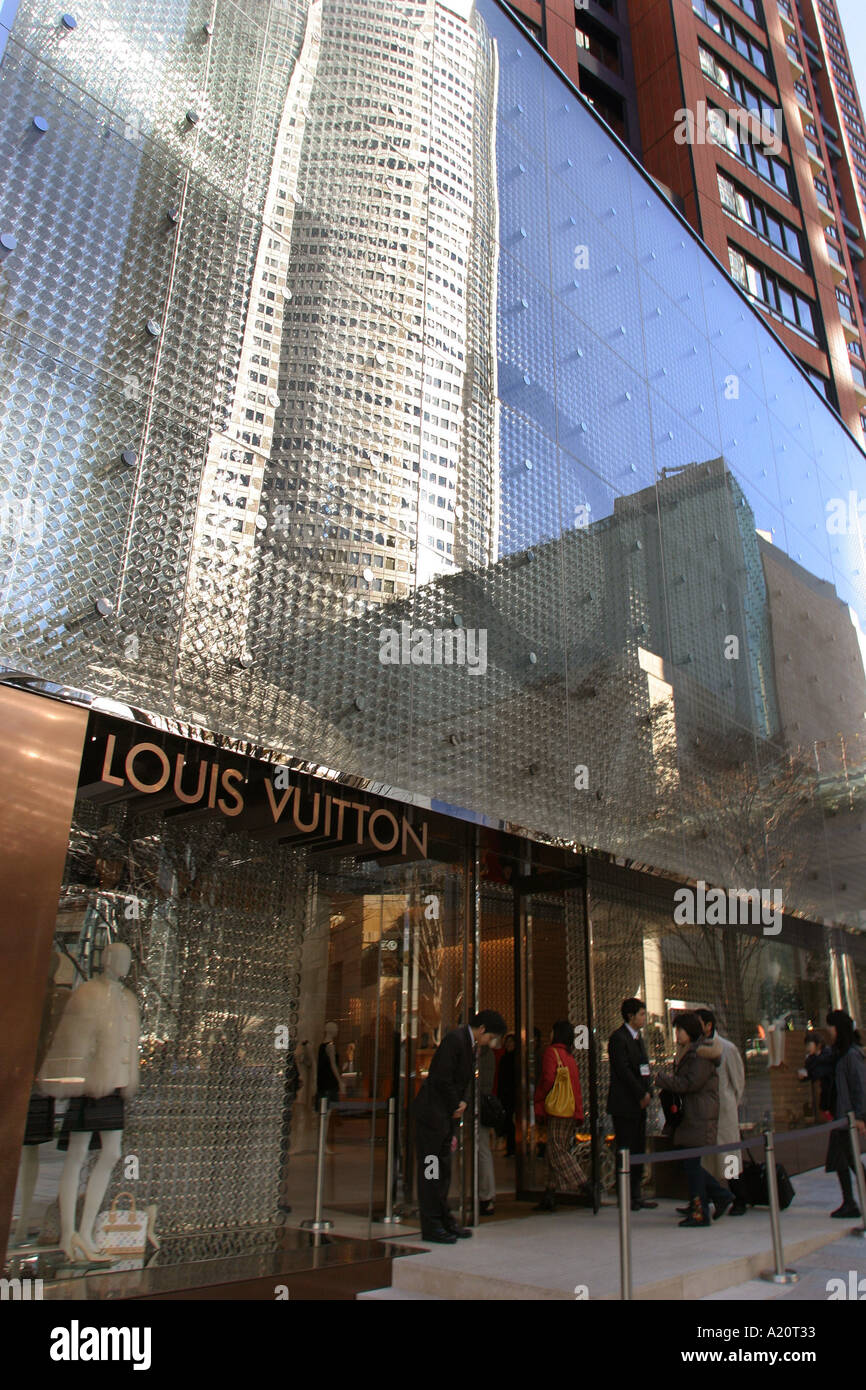 Mori Tower reflected in the front of the designer clothes Louis Vuitton  store in Roppongi Hills, Tokyo, Japan Stock Photo - Alamy