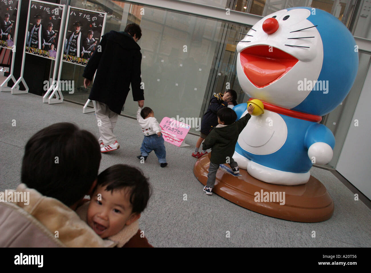 Children playing on a sculpture of a television character in the TV Asahi television building in Roppongi Hills, Tokyo, Japan Stock Photo