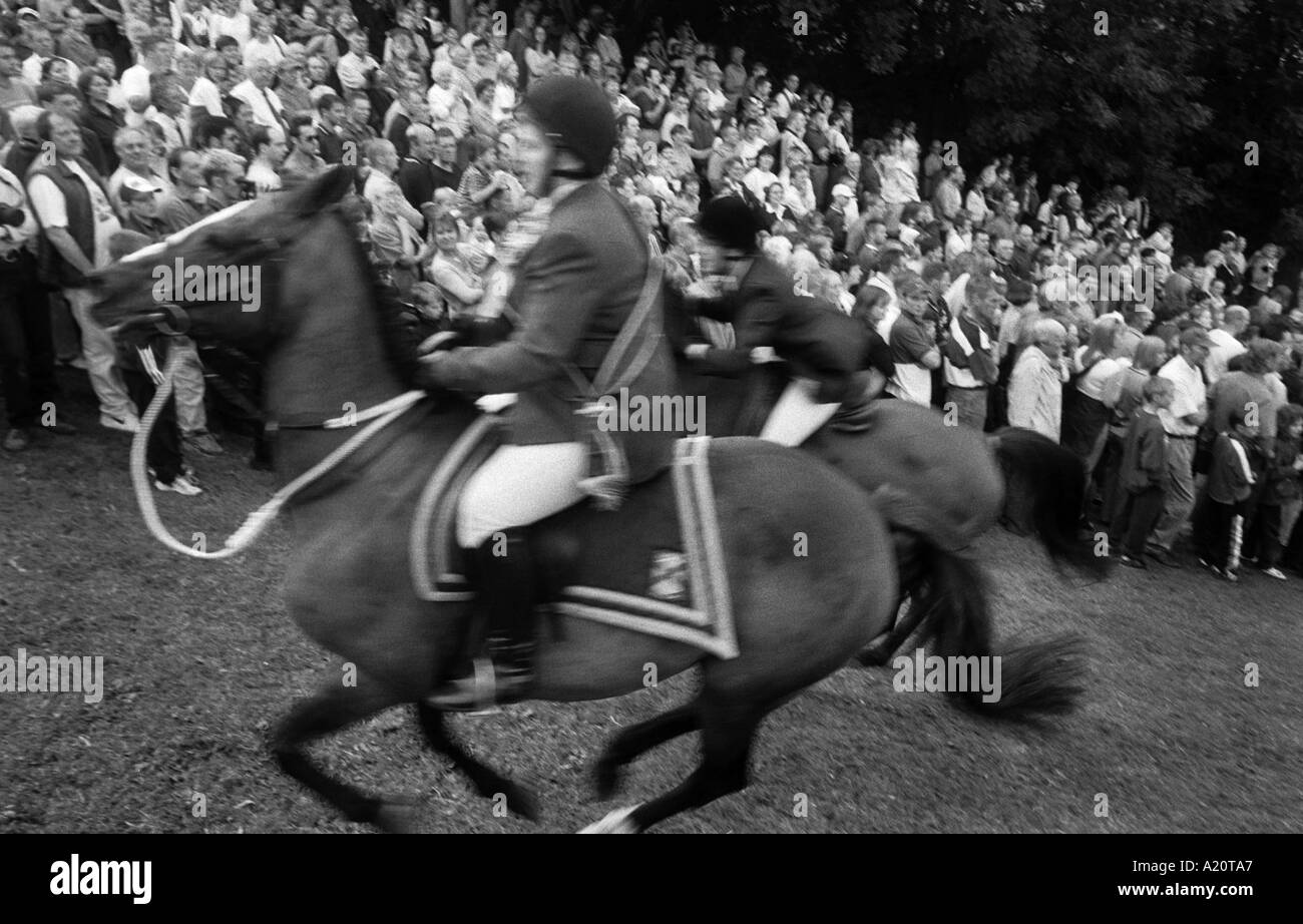 Horsemen and their horses on the ride out up the Kirk Wynd during Common Riding week in Langholm, in the Scottish borders. Stock Photo