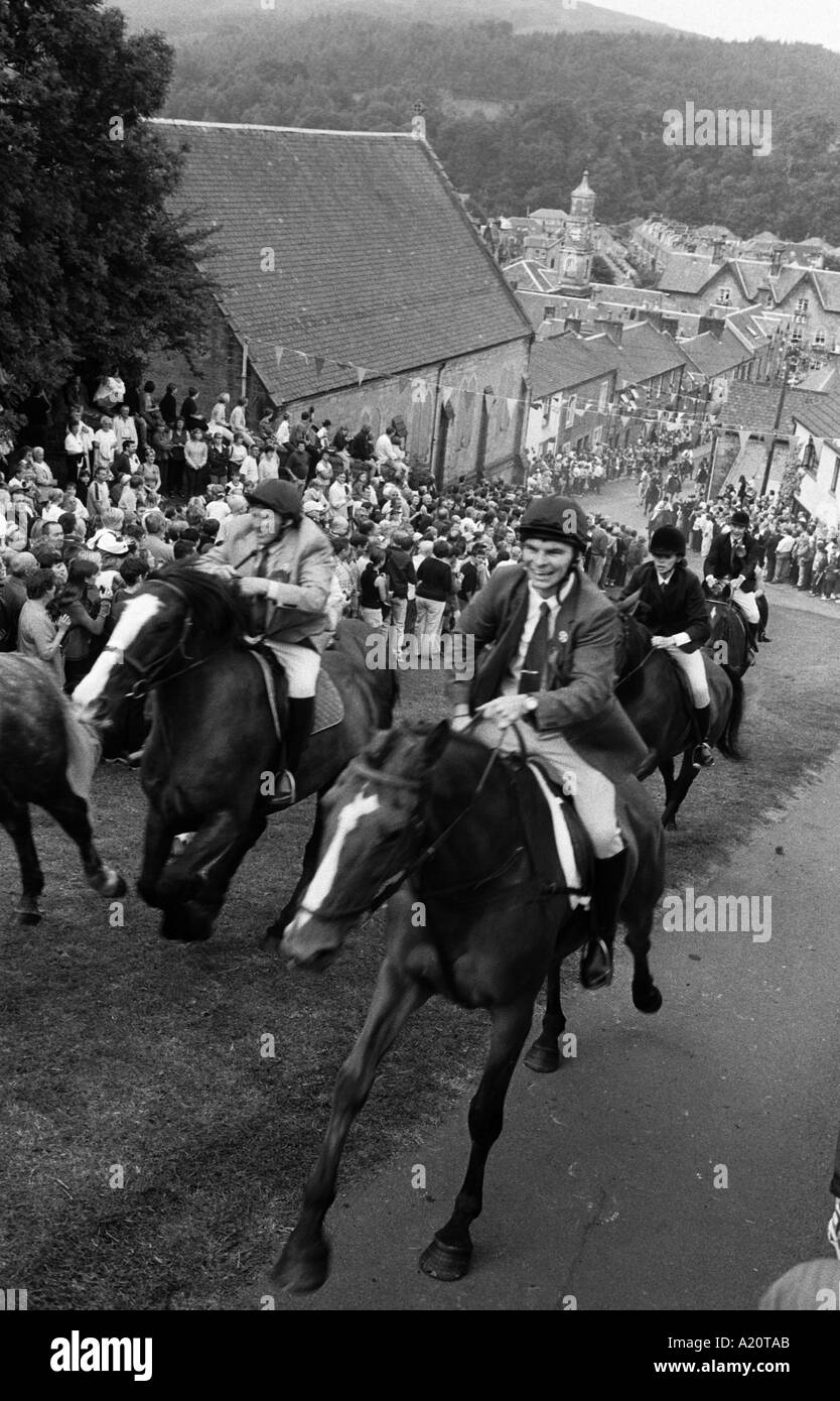 Horsemen and their horses on the ride out up the Kirk Wynd, during Common Riding week in Langholm near the Scottish borders. Stock Photo