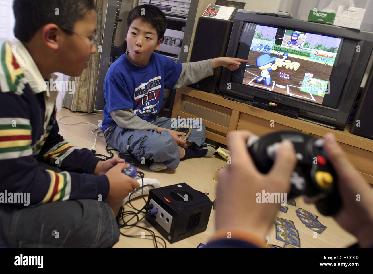 Japanese children playing Nintendo Gamecube and Gameboy, Tokyo, Japan Stock Photo
