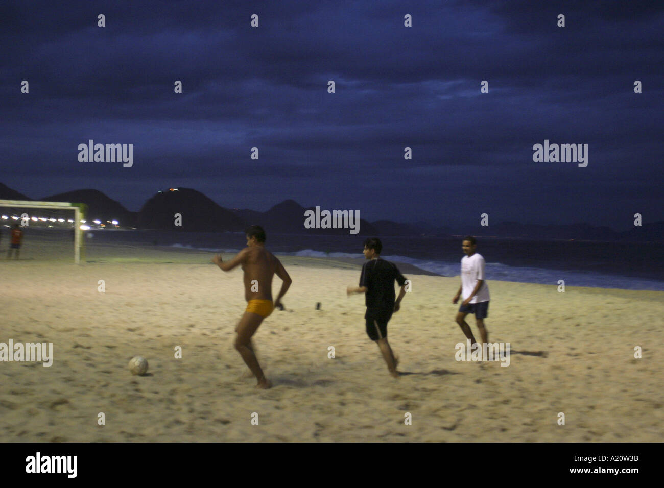 Men playing football on Copacabana beach in the evening , Rio de Janeiro, Brazil. Stock Photo