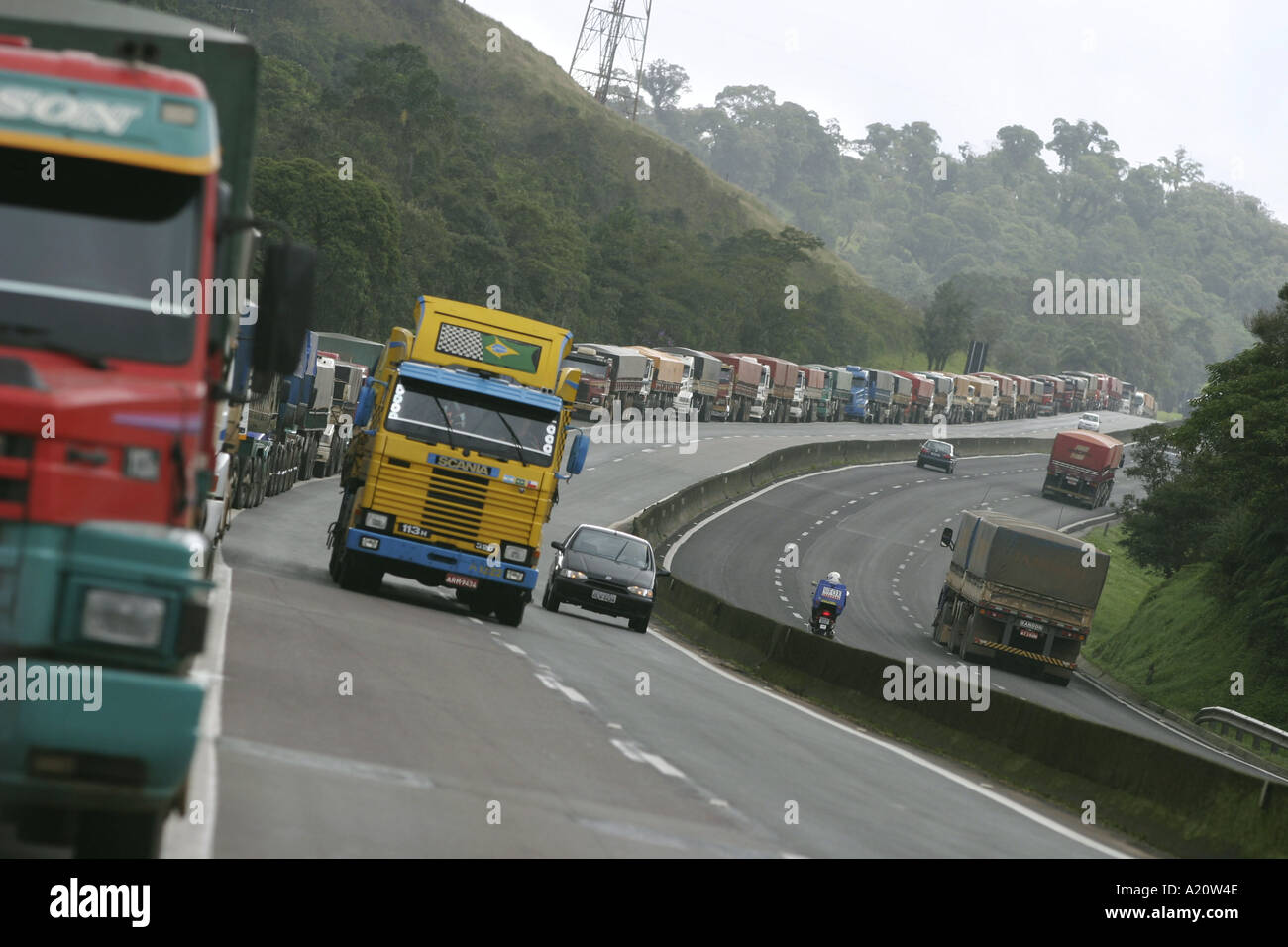 Queues of trucks on road to Paranagua waiting to unload and load at the port, Brazil, South America. Stock Photo