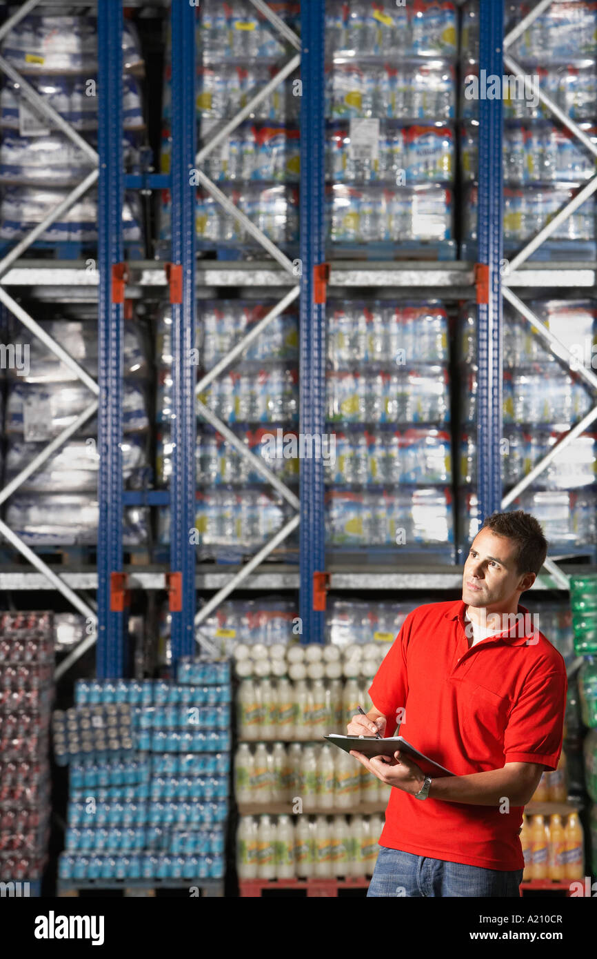 Warehouse Worker Checking Inventory Stock Photo