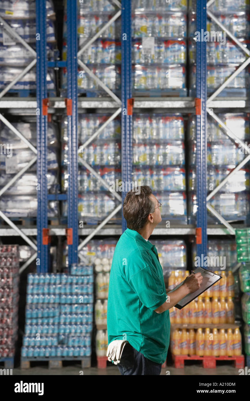 Warehouse Worker Checking Inventory, side view Stock Photo