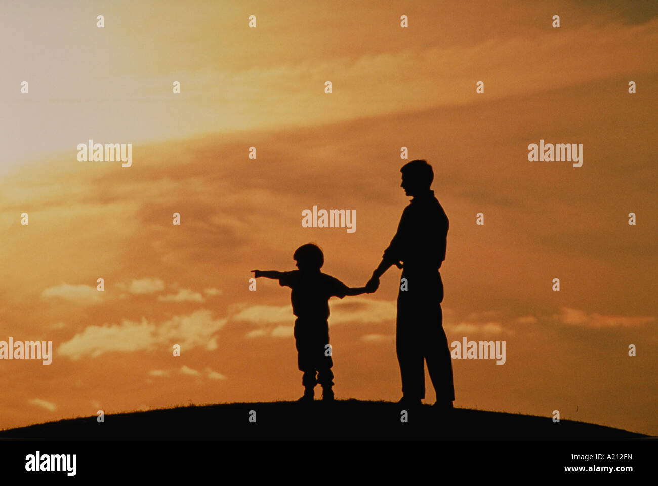 Silhouette of father and son with sunset Stock Photo