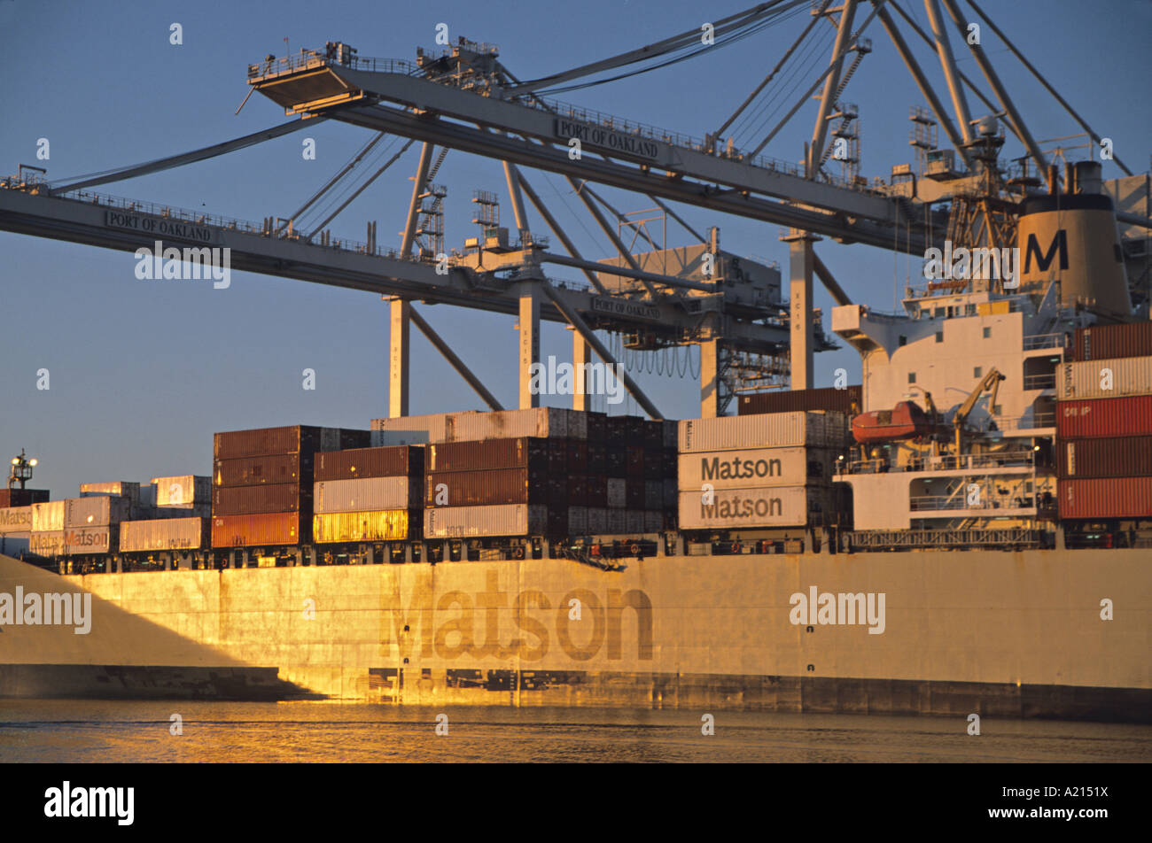sunset reflecting off container ship Port of Oakland California Stock Photo