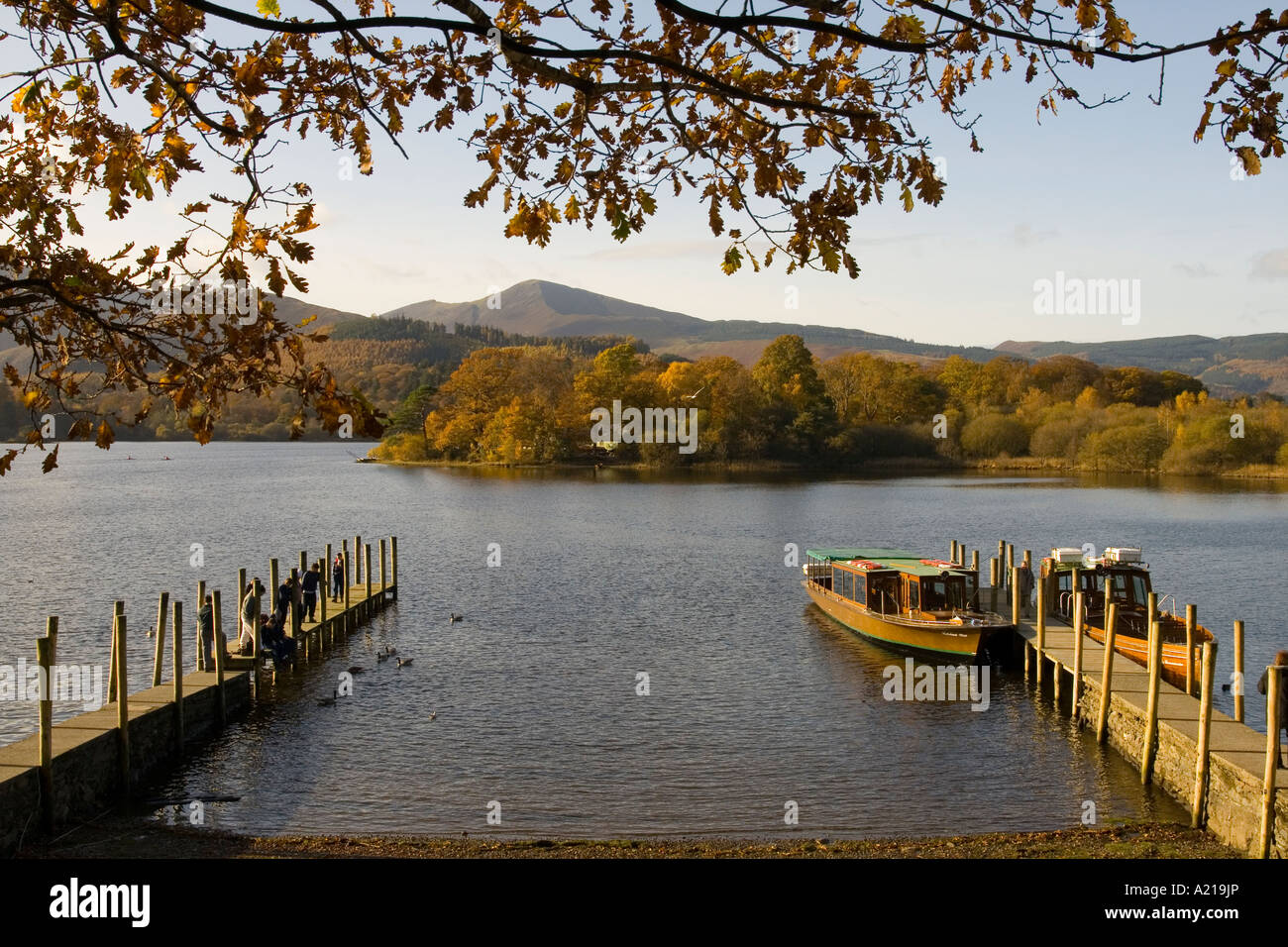 Golden hour sun lit boat at Derwent Water in the Lake district near Kewsick Stock Photo