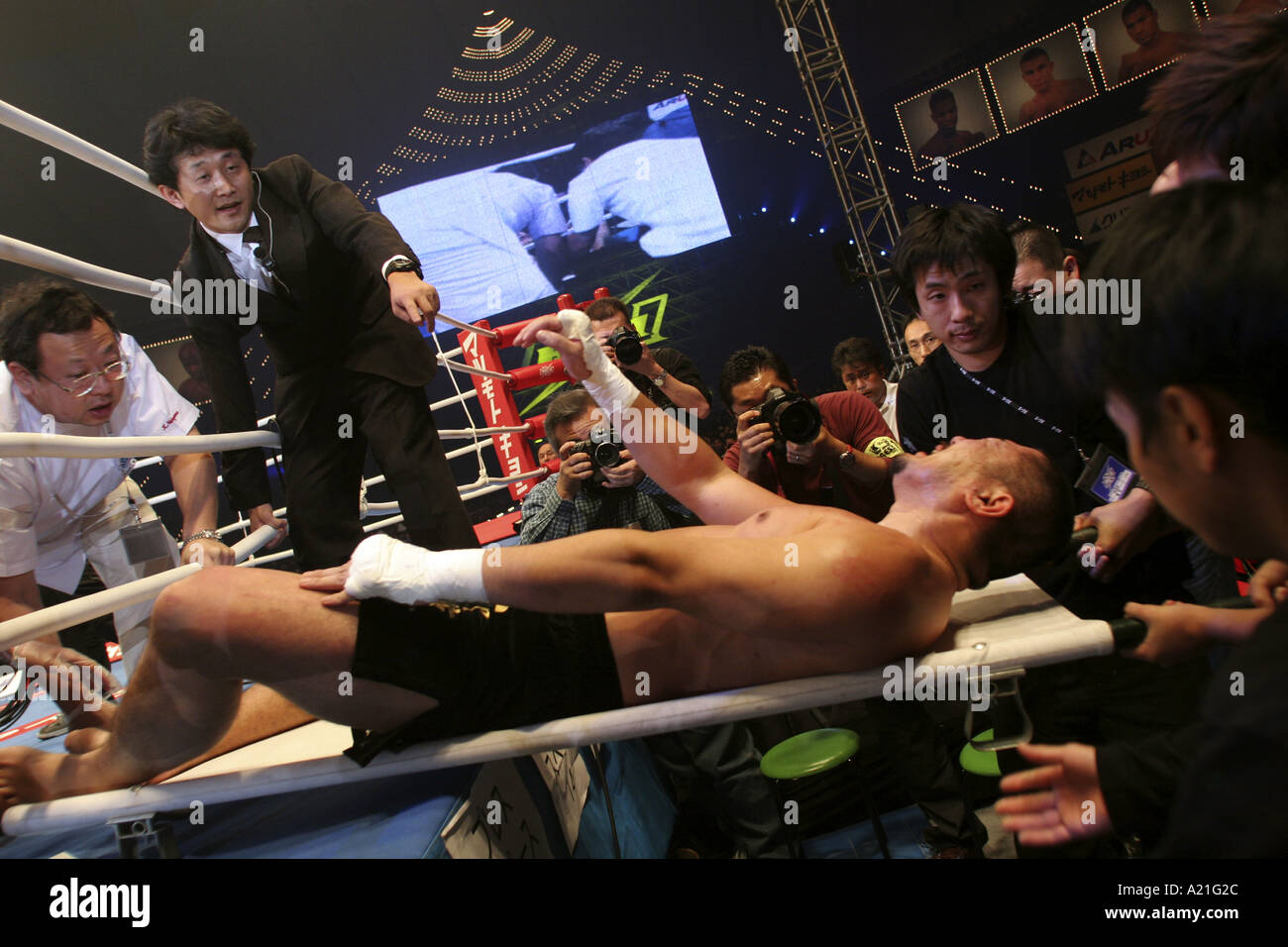 K-1 fighter is carried from the ring on a stretcher after defeat by knock-out, Tokyo, Japan Stock Photo