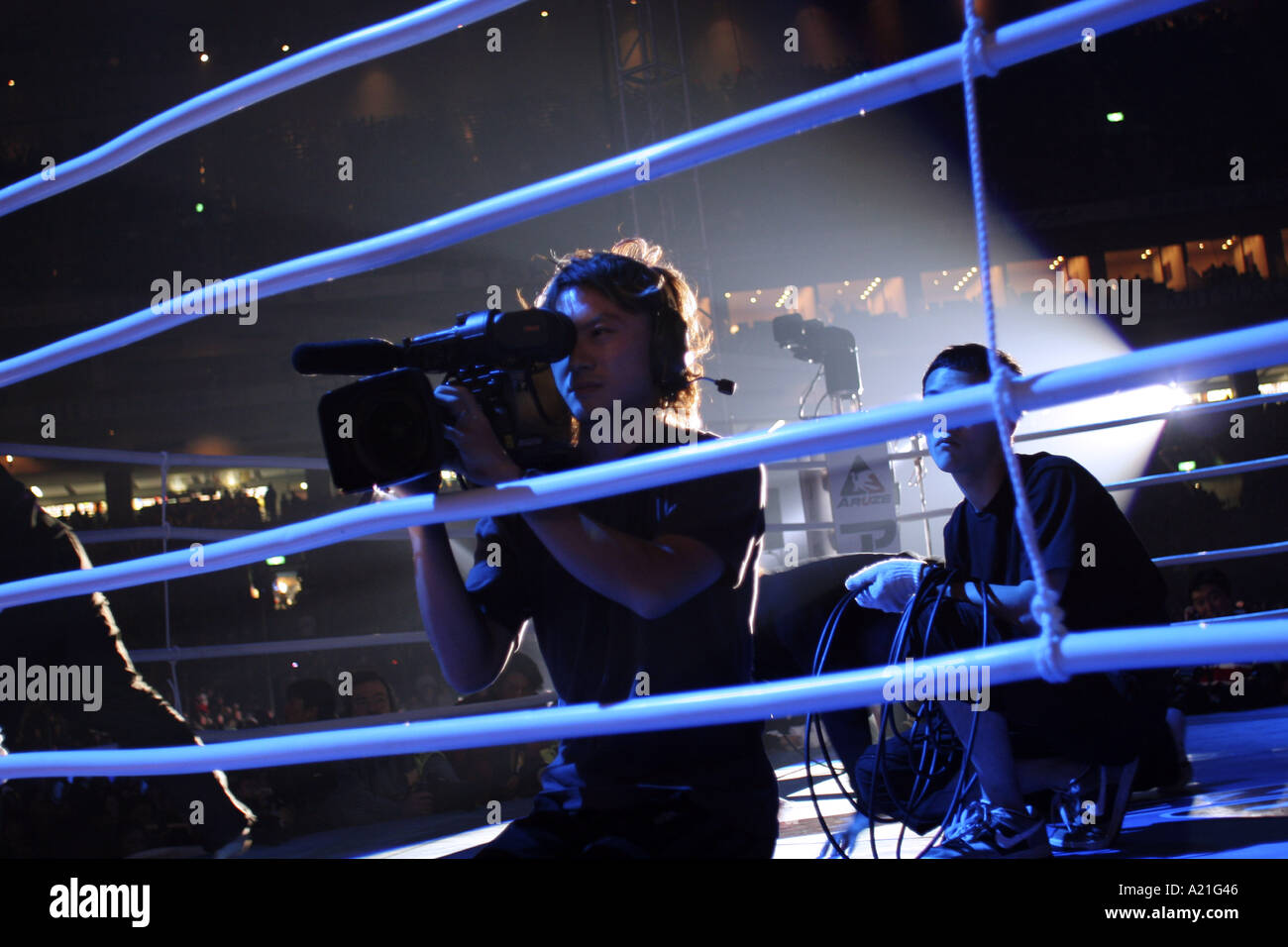 A television cameraman in the ring before the match fights of the K 1 World GP 2004 held at Tokyo Dome Stock Photo