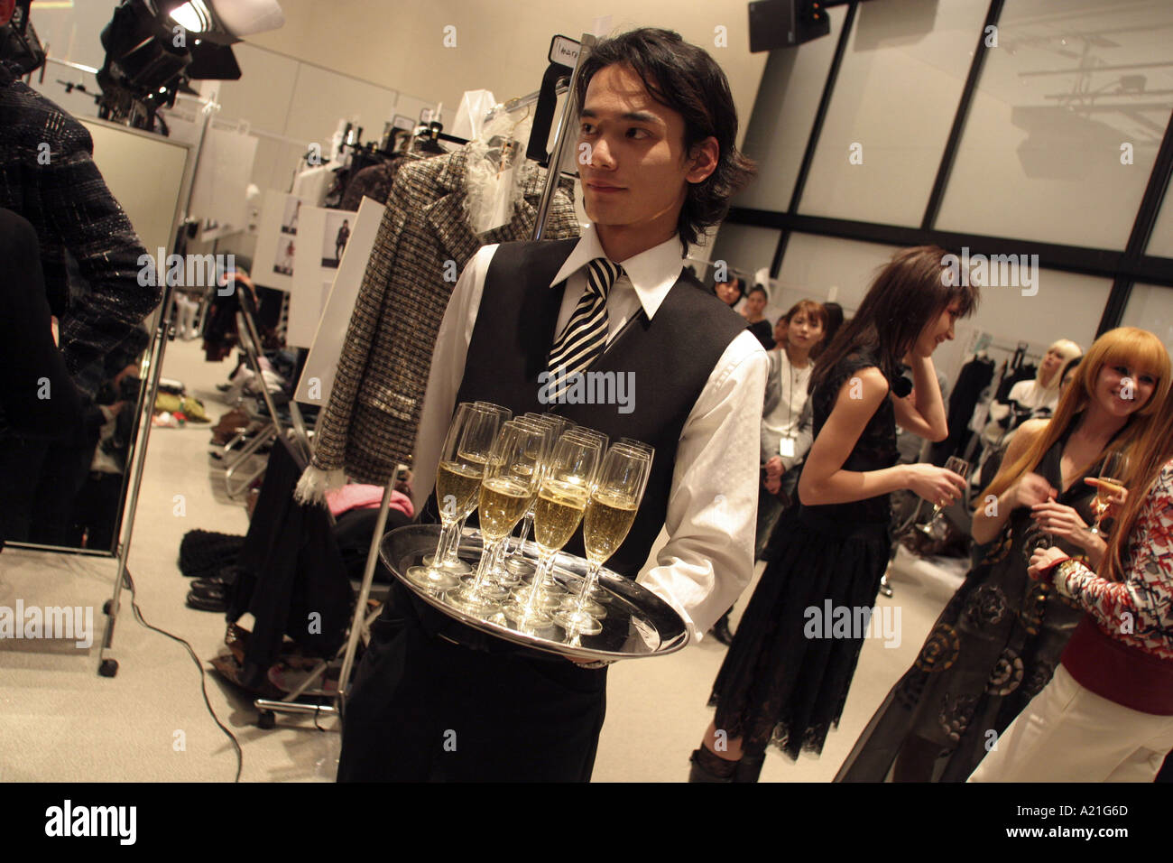 Waiter and models backstage with champagne after Chanel fashion show ...
