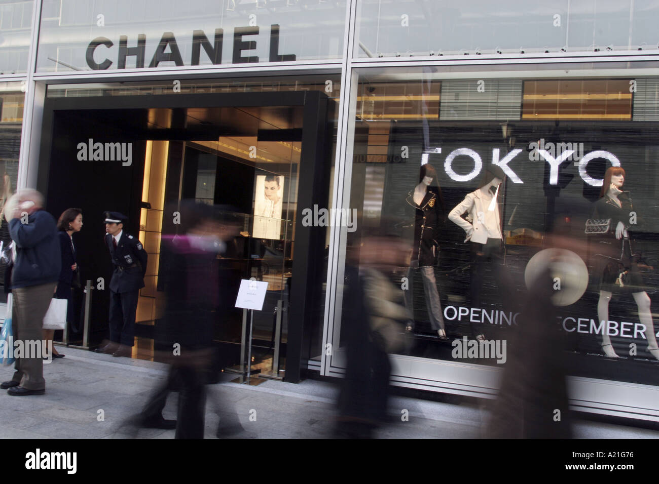 Japanese pedestrians walk past the new Chanel fashion store in Ginza