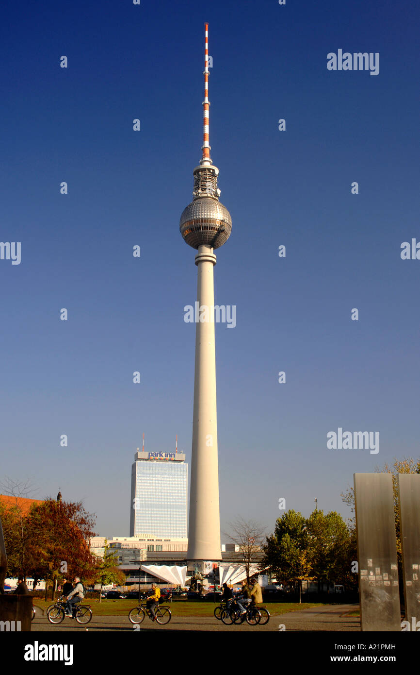 Cyclists at the foot of the Fernsehturm TV Tower at The Marx Engels Platz in East Berlin. Stock Photo