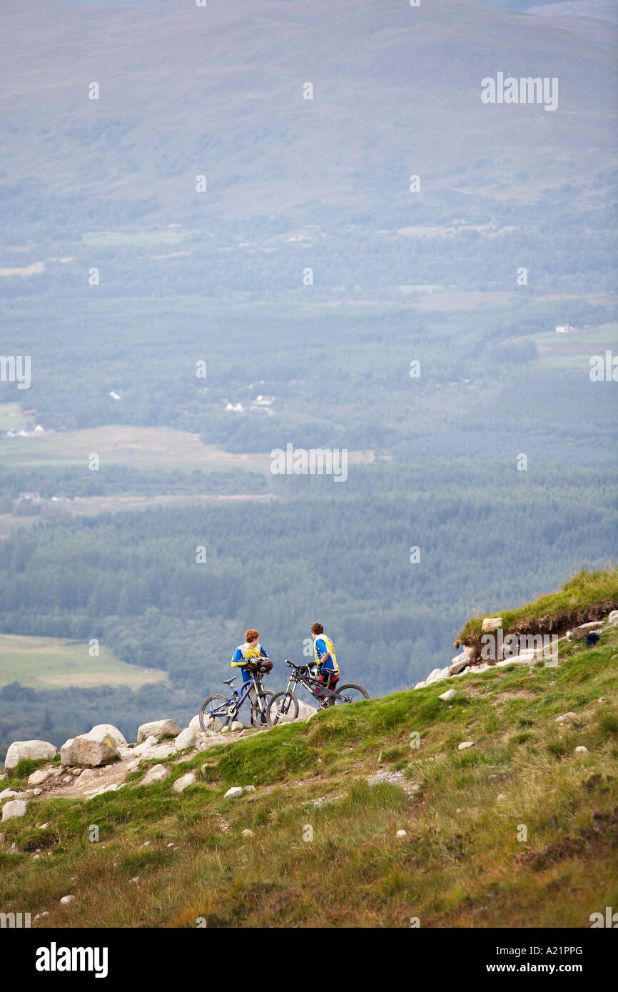 Boys Mountain Biking on Hillside, Aonach Mor, Scotland Stock Photo