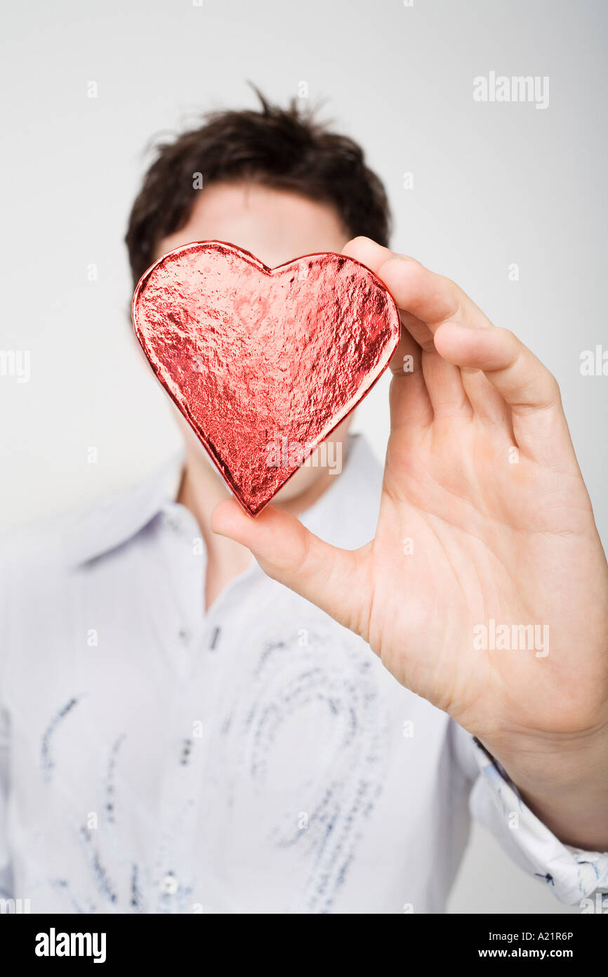 Man Holding Heart-Shaped Box Stock Photo