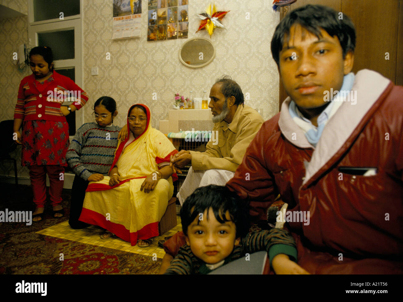 A Bangladesh family at home in Tower  Hamlets. Their home suffers from dreadful  damp, East London, UK Stock Photo