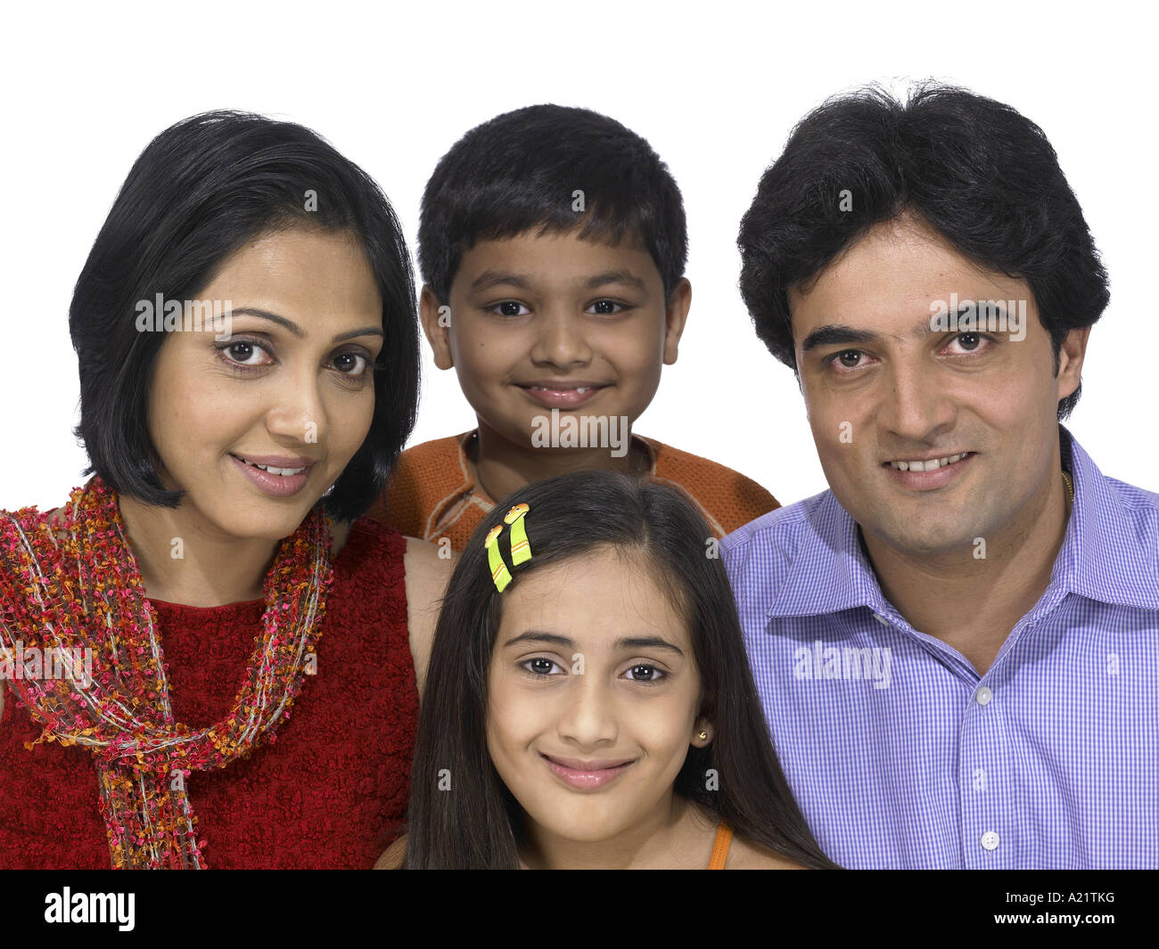 South Asian Indian family with father mother son and daughter smiling Stock Photo