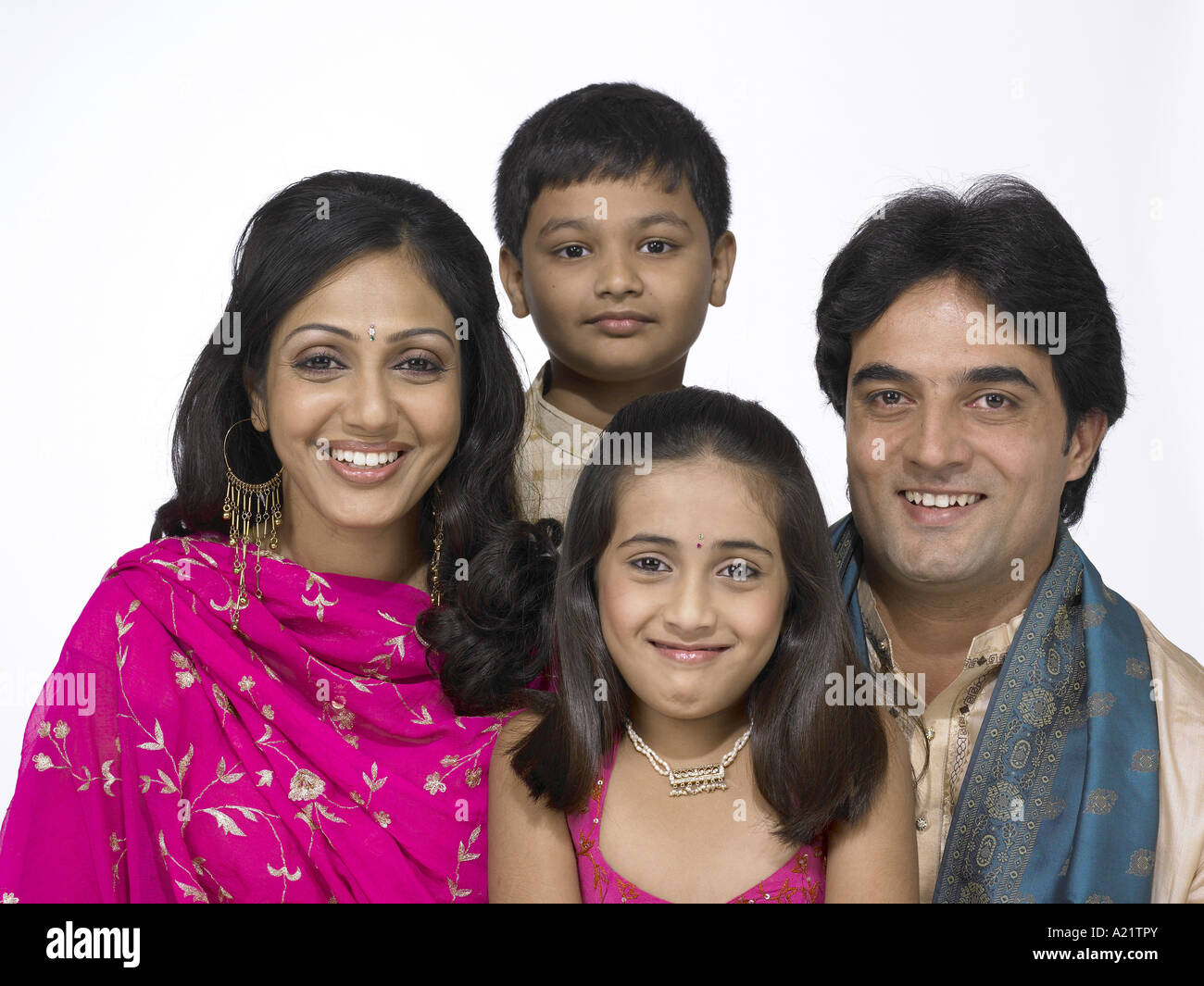 South Asian Indian family with father mother son and daughter wearing traditional dress kurta pajama Stock Photo
