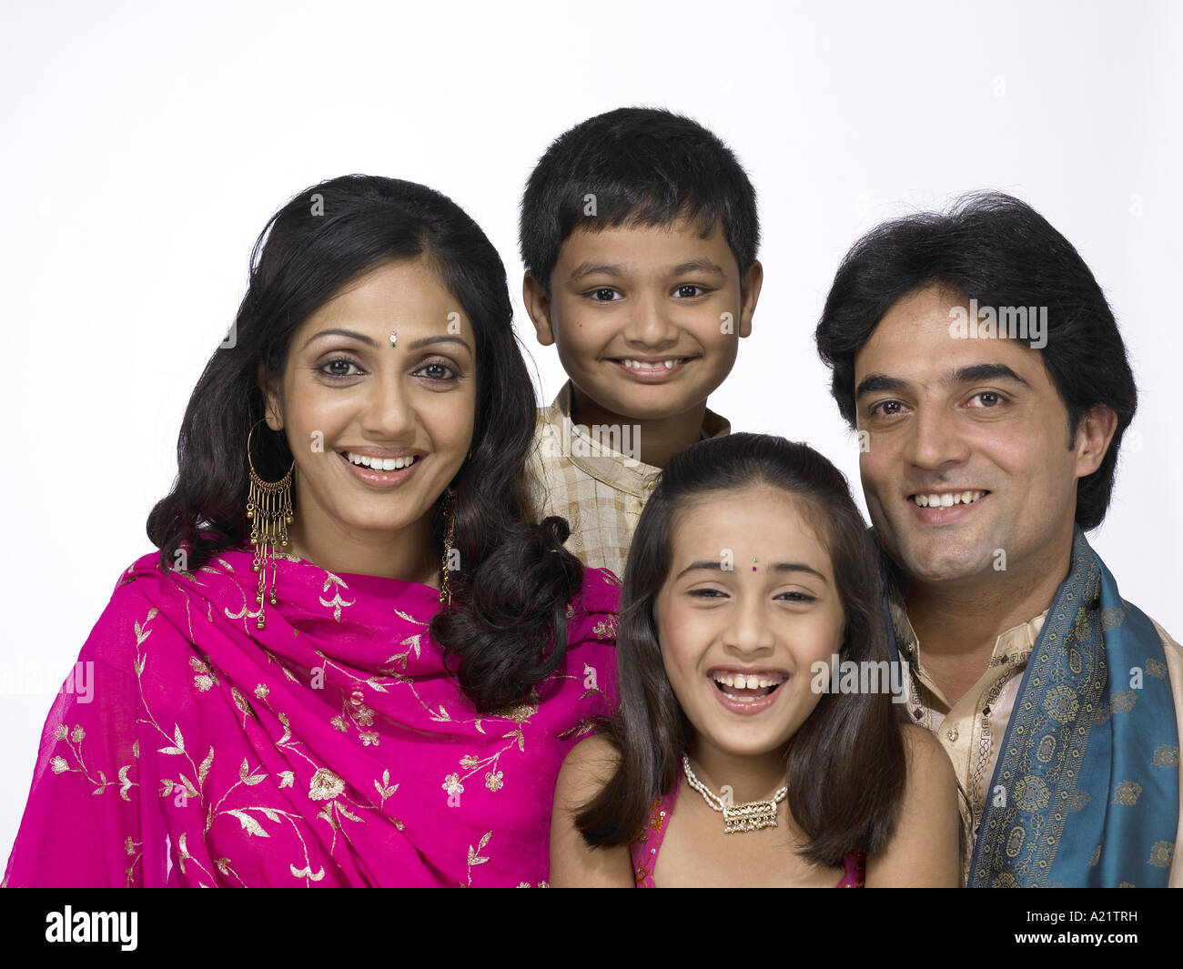 South Asian Indian family with father mother son and daughter wearing traditional dress kurta pajama Stock Photo