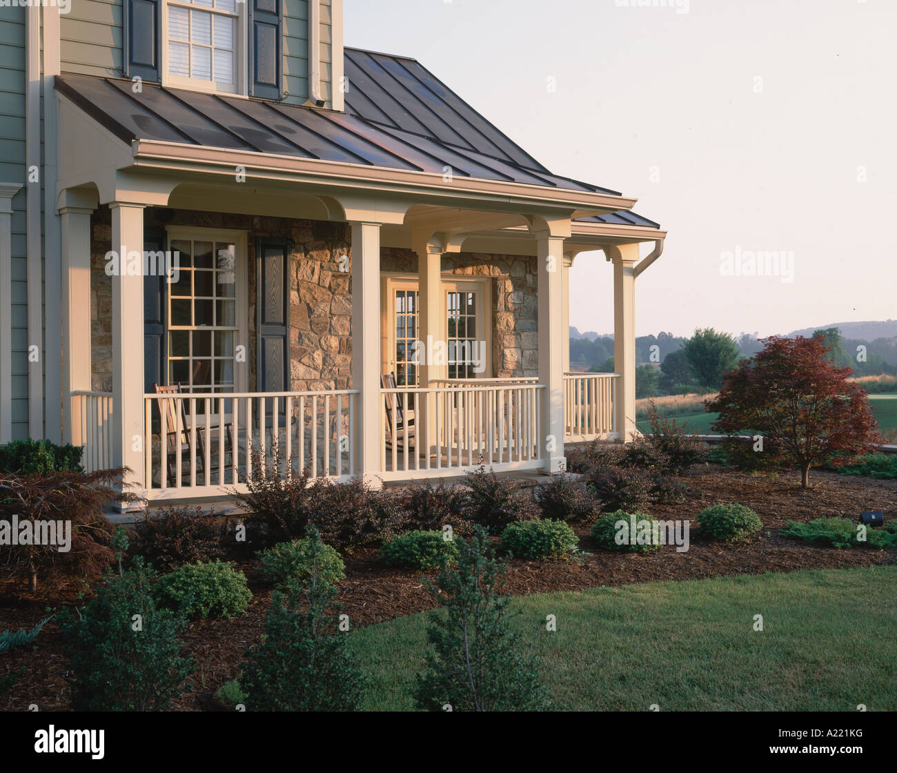 Large wrap around porch with shrubs Stock Photo