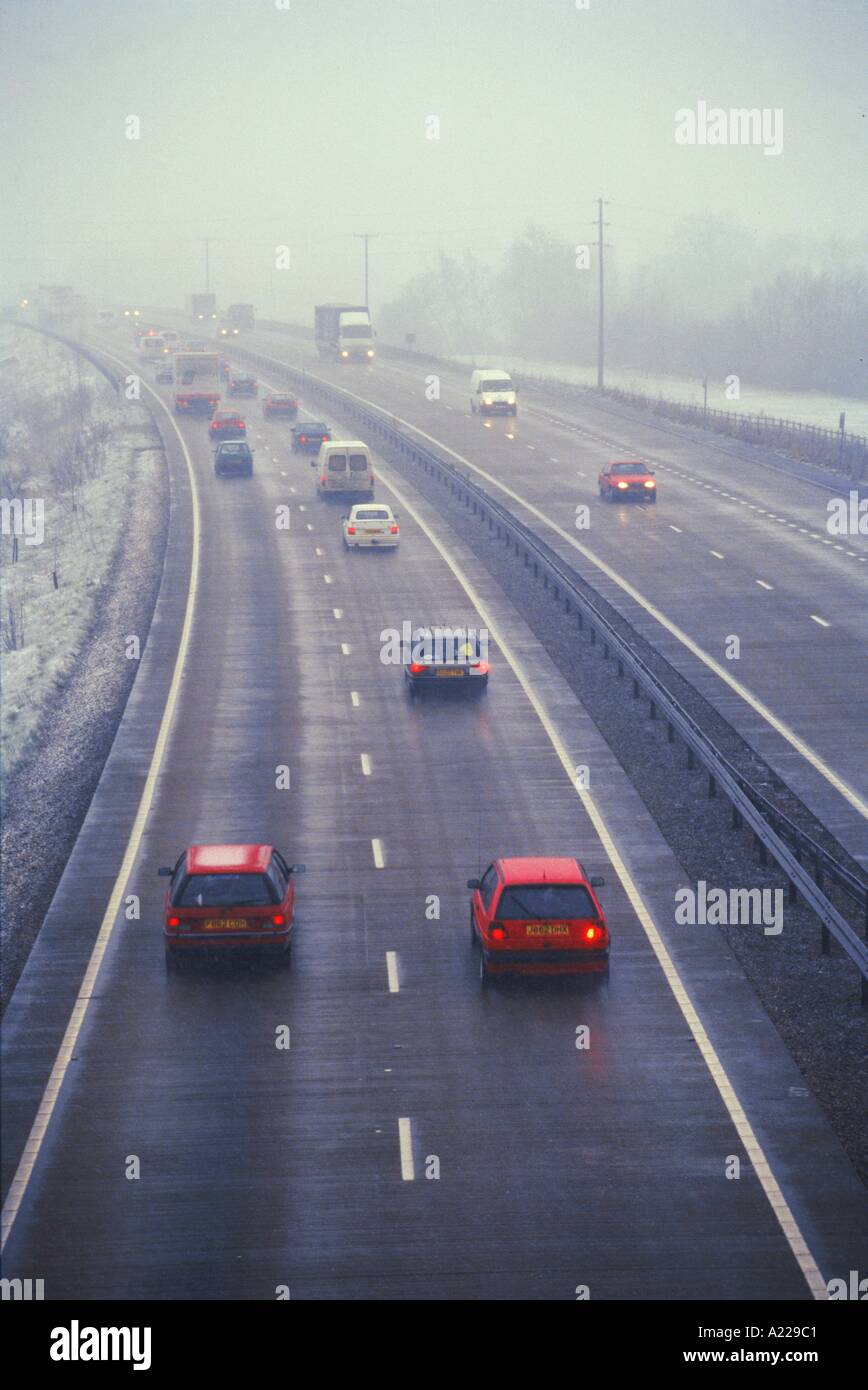 Motorway traffic in mist and sleet N Francis Stock Photo
