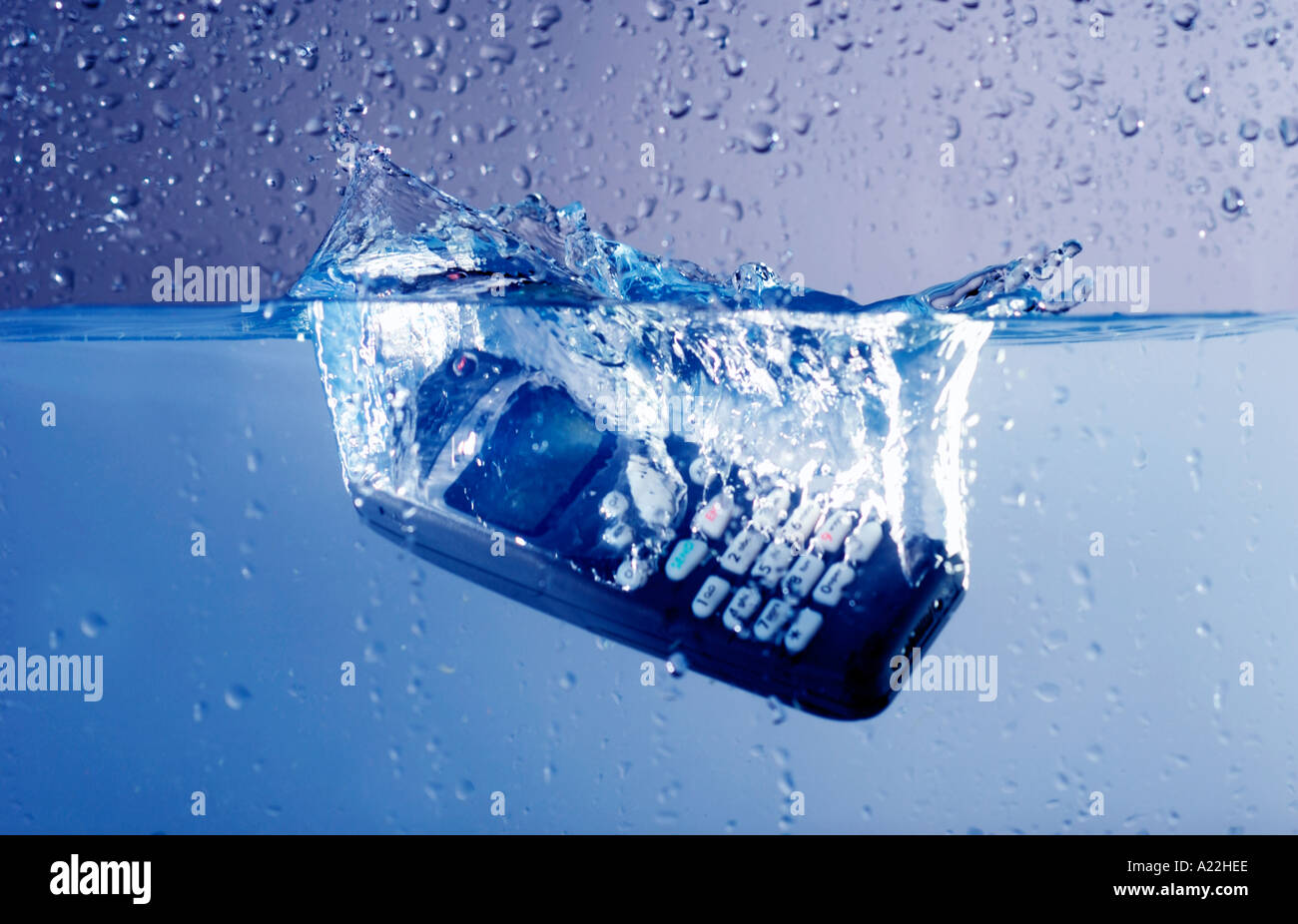 cell phone dropped in water makes splash and bubbles Stock Photo Alamy