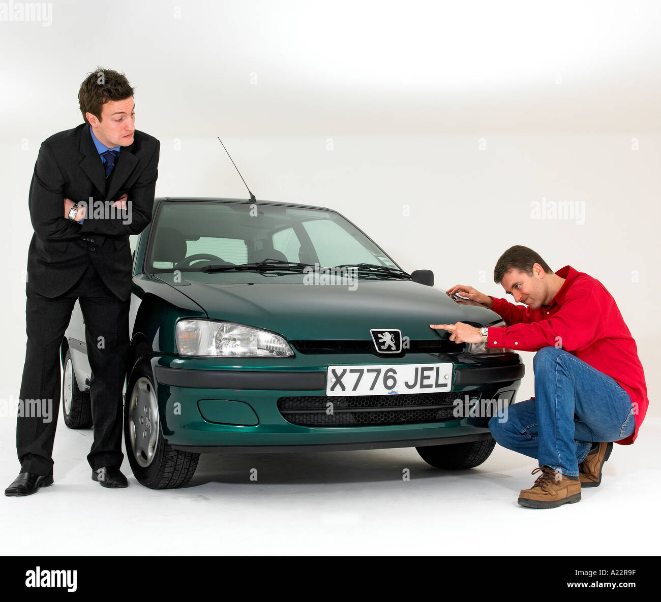 Car salesman helping a buyer make his choice Stock Photo
