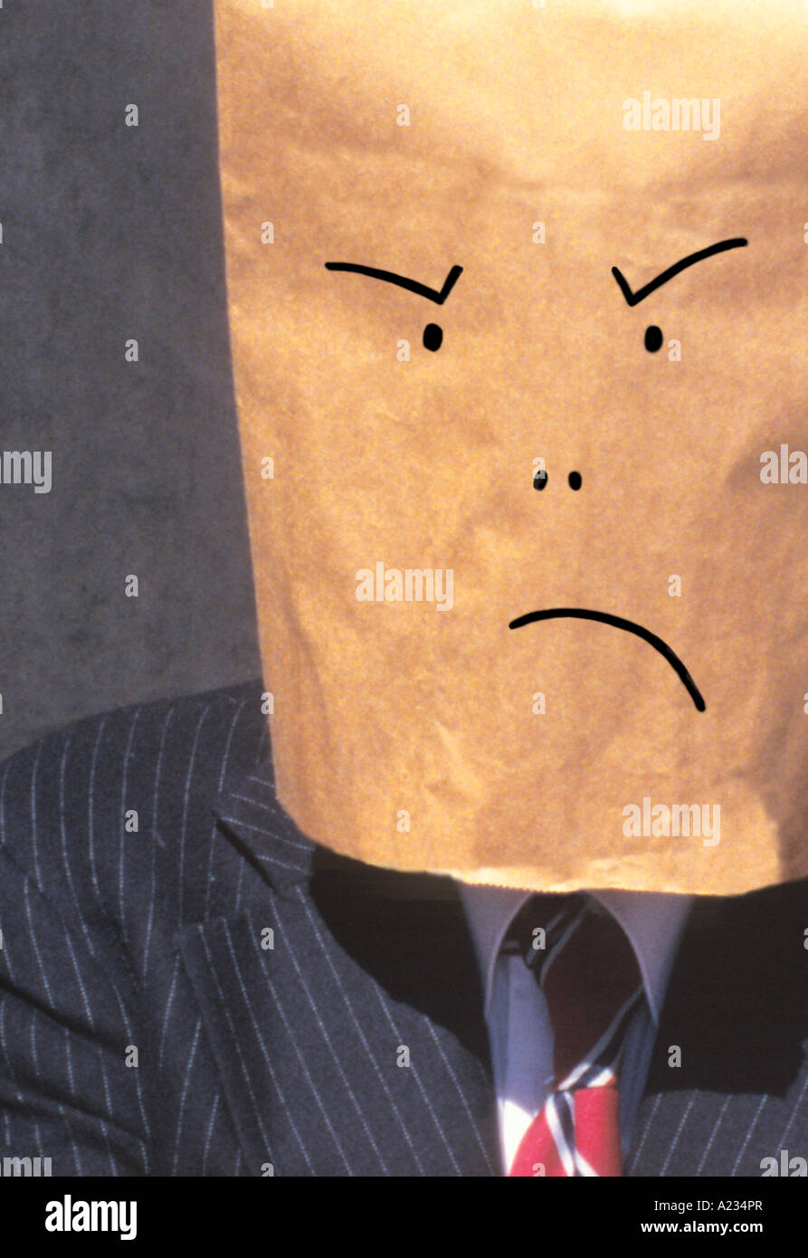 Businessman brown paper bag over head frowning Stock Photo