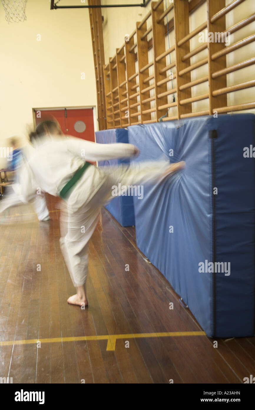 Kick practice at karate club in school gym hall Stock Photo - Alamy