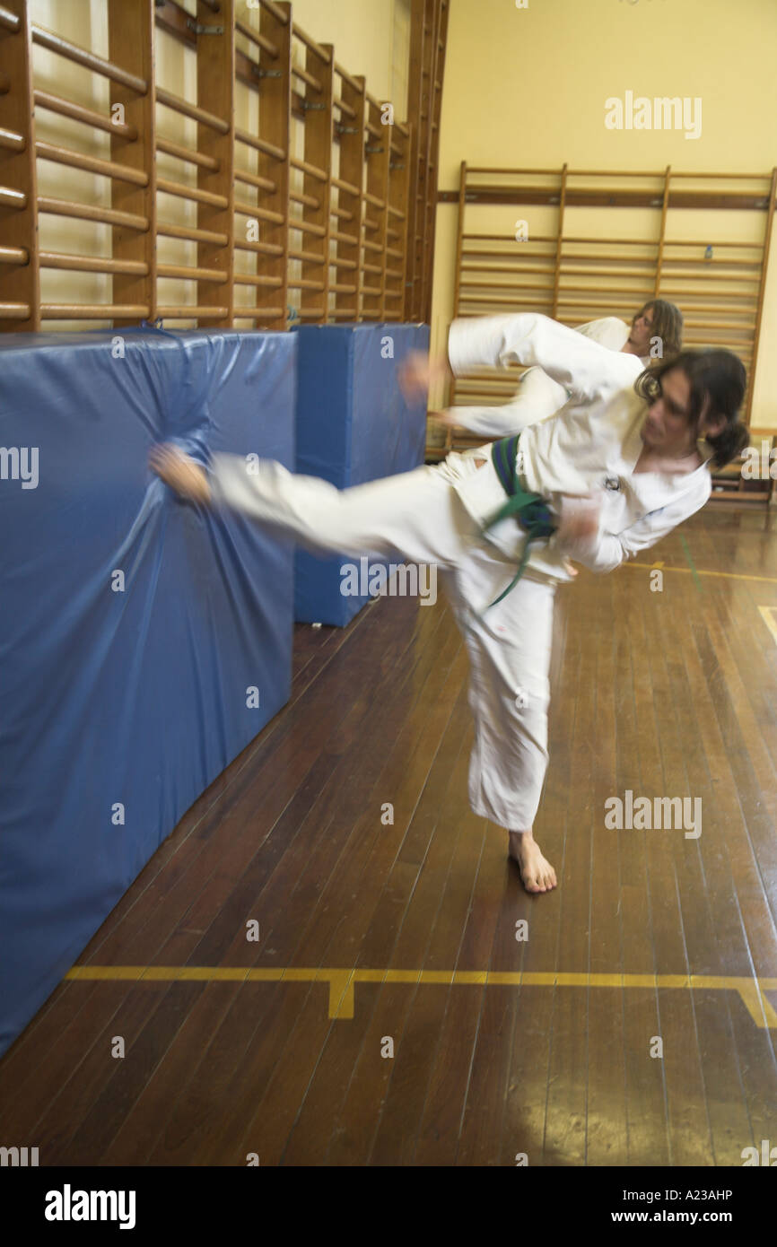 Kick practice at karate club in school gym hall Stock Photo - Alamy