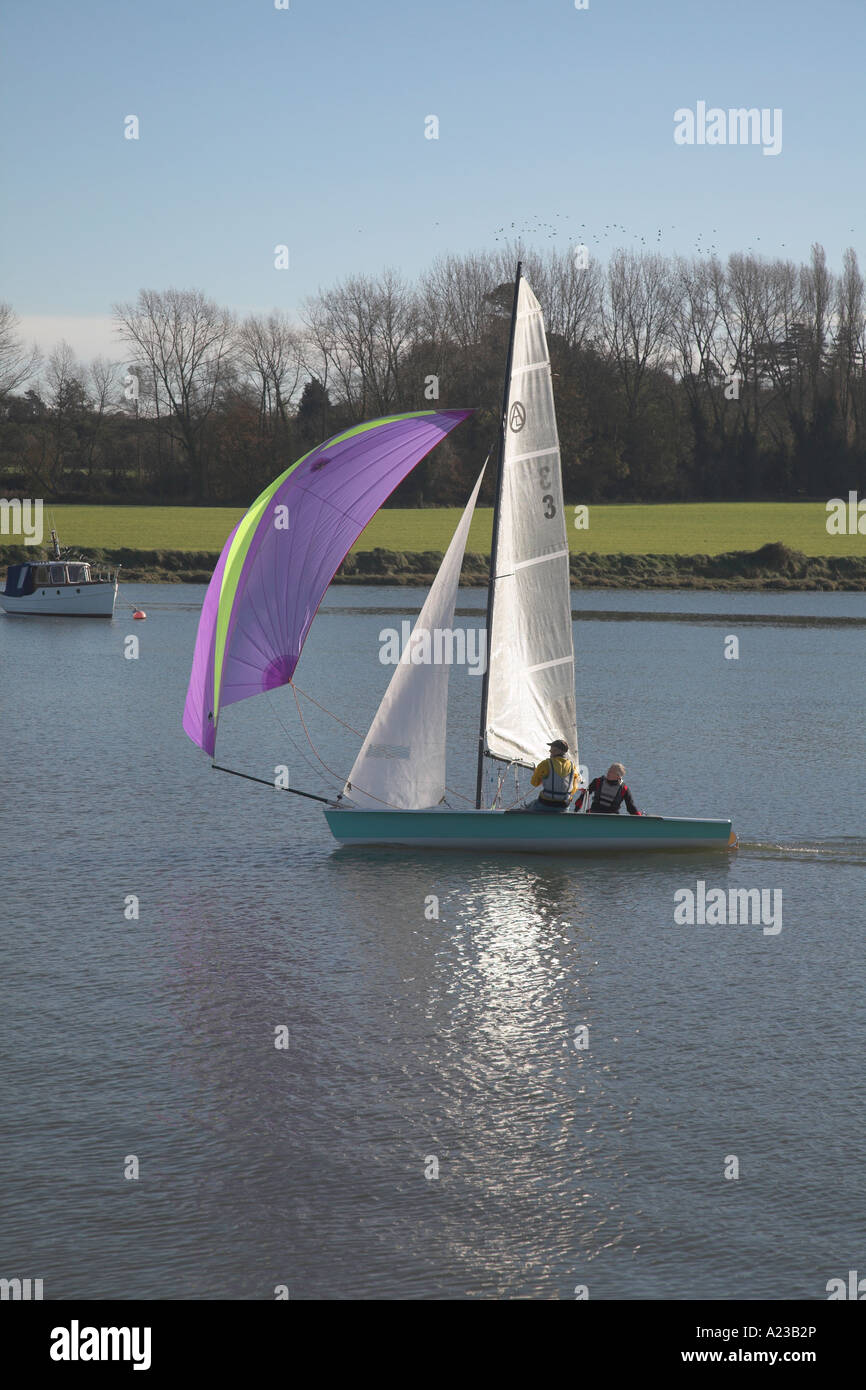 Two person sailing dinghy with jib, main sail and spinnaker River Deben