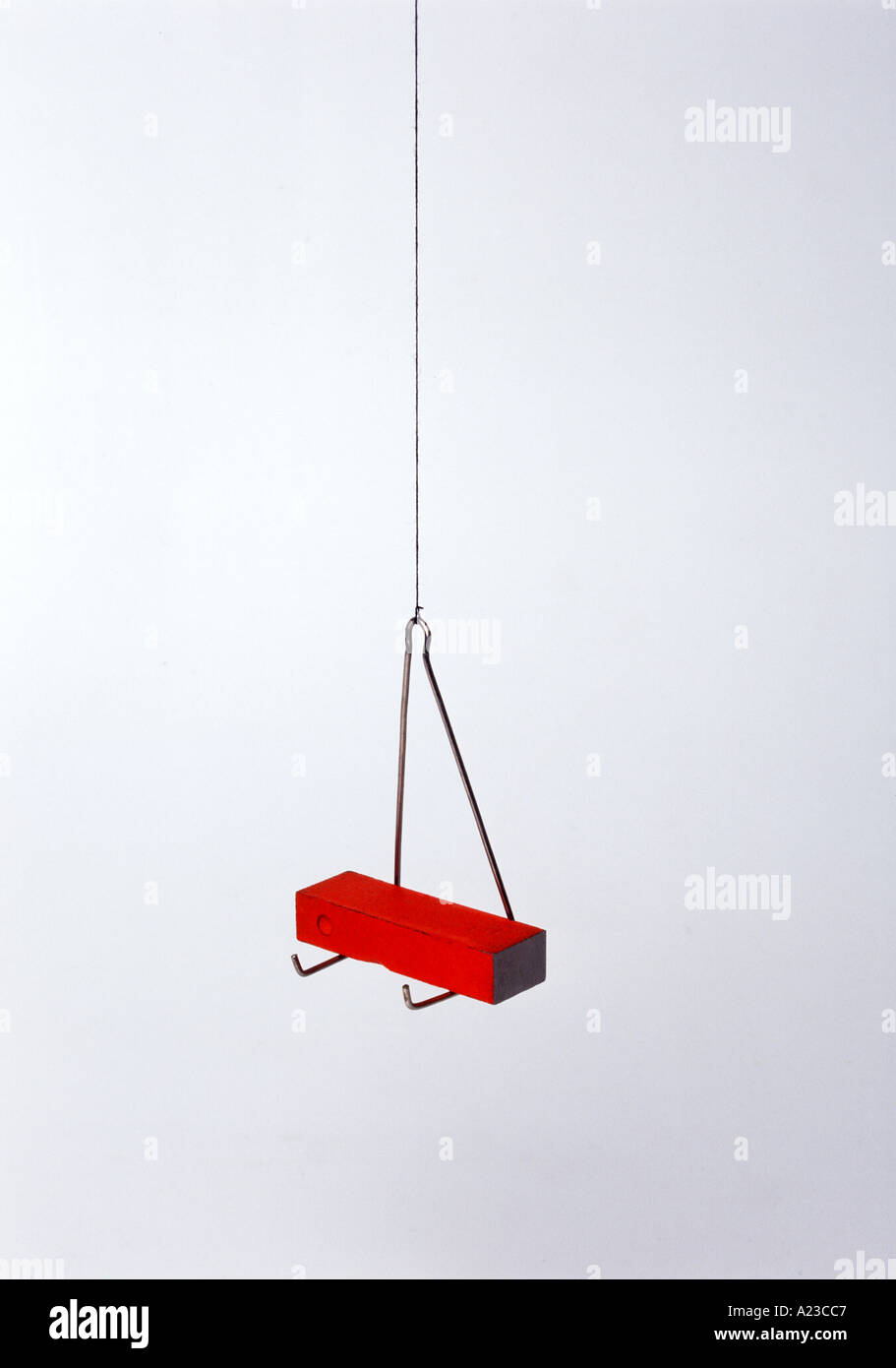 a bar suspended in a stirrup points north south Stock Photo Alamy