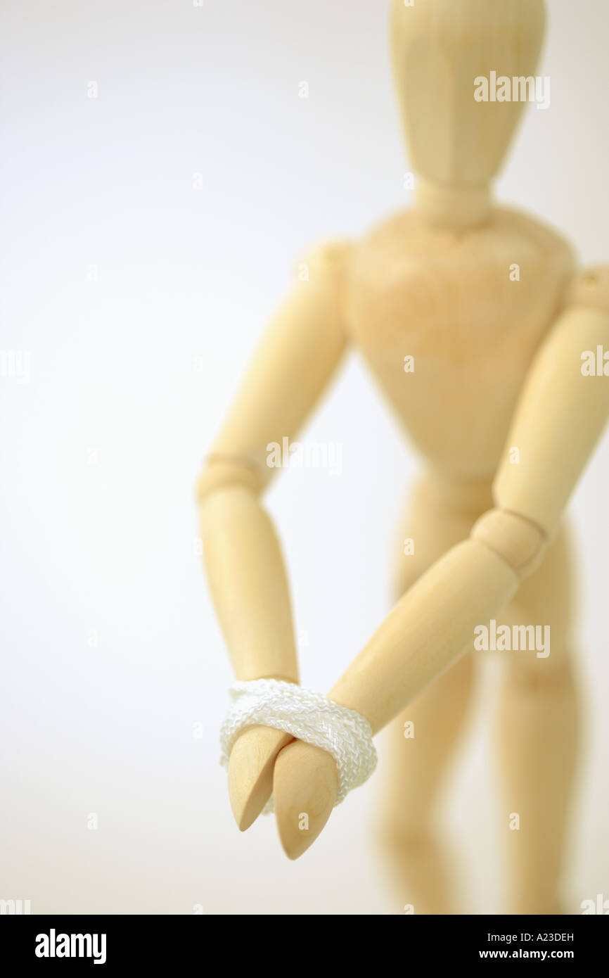 Wooden mannequin tied Stock Photo