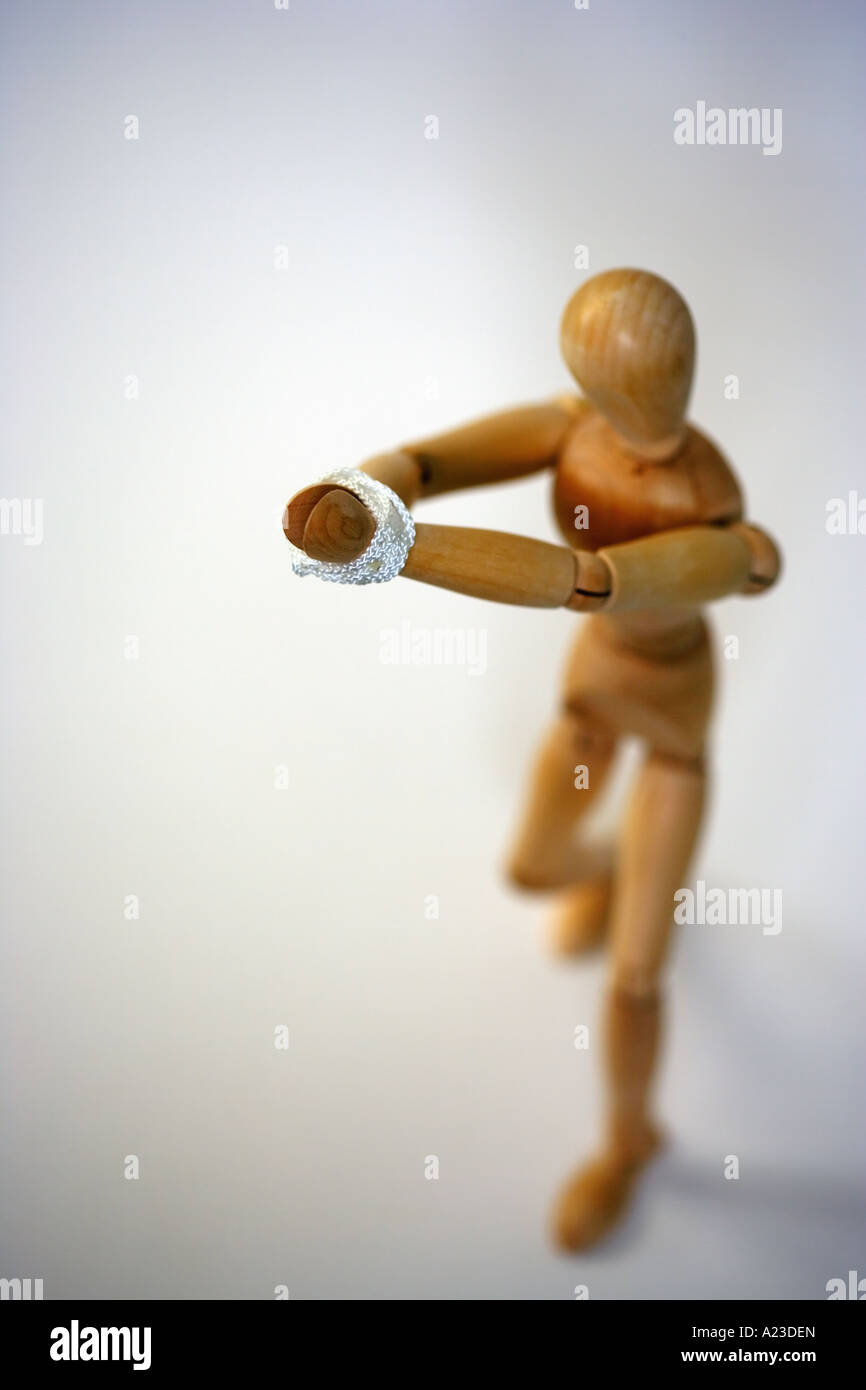 Wooden mannequin tied Stock Photo