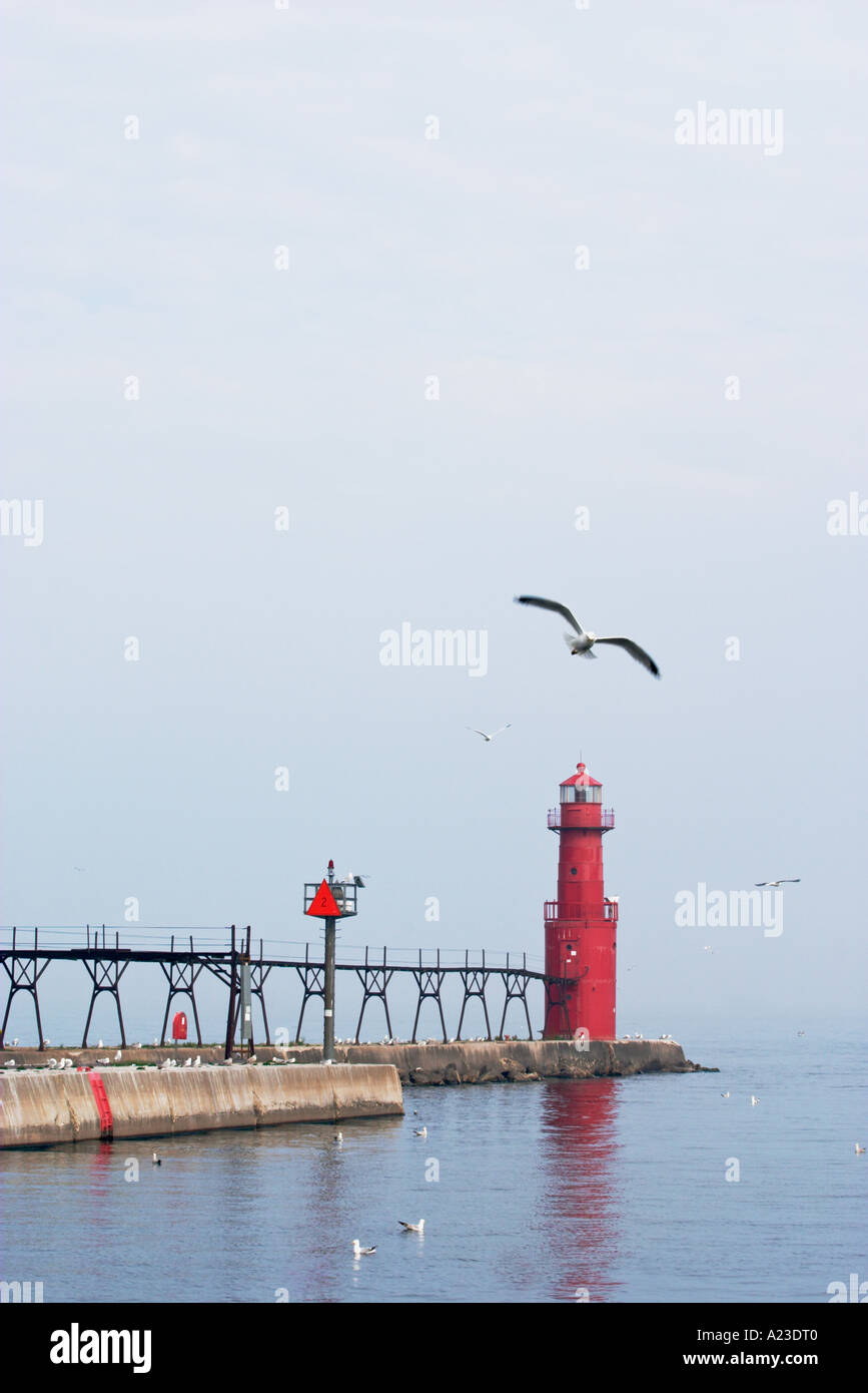 Algoma Lighthouse in Wisconsin with sea gull flying overhead. Stock Photo