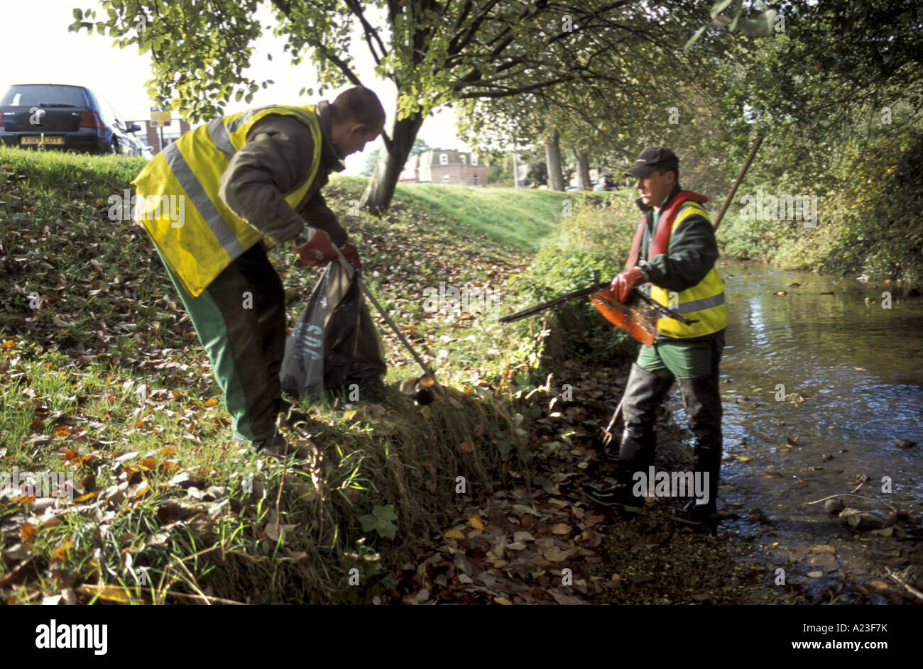 Council workmen remove rubbish from the river Nadder in Salisbury Wiltshire England Stock Photo