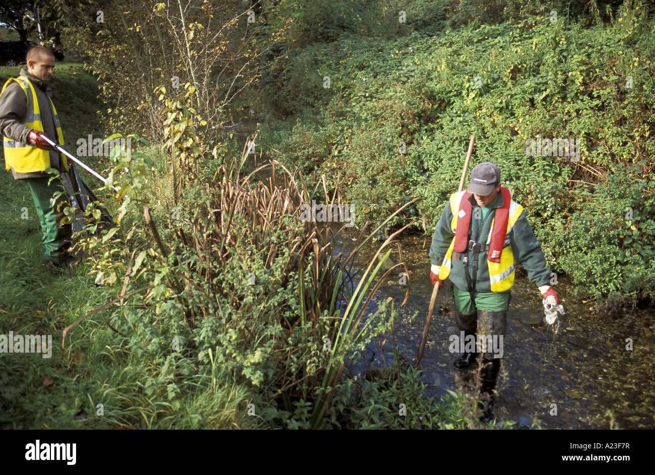 Council workmen remove rubbish from the river Nadder in Salisbury Wiltshire England Stock Photo