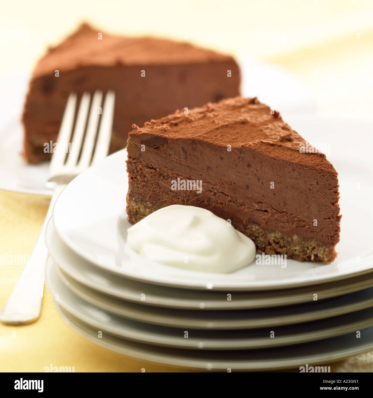 Chocolate torte gateau with cream biscuit base on plates with fork Stock  Photo - Alamy