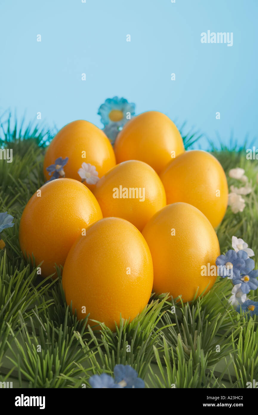 seven yellow easter eggs on artificial lawn Stock Photo