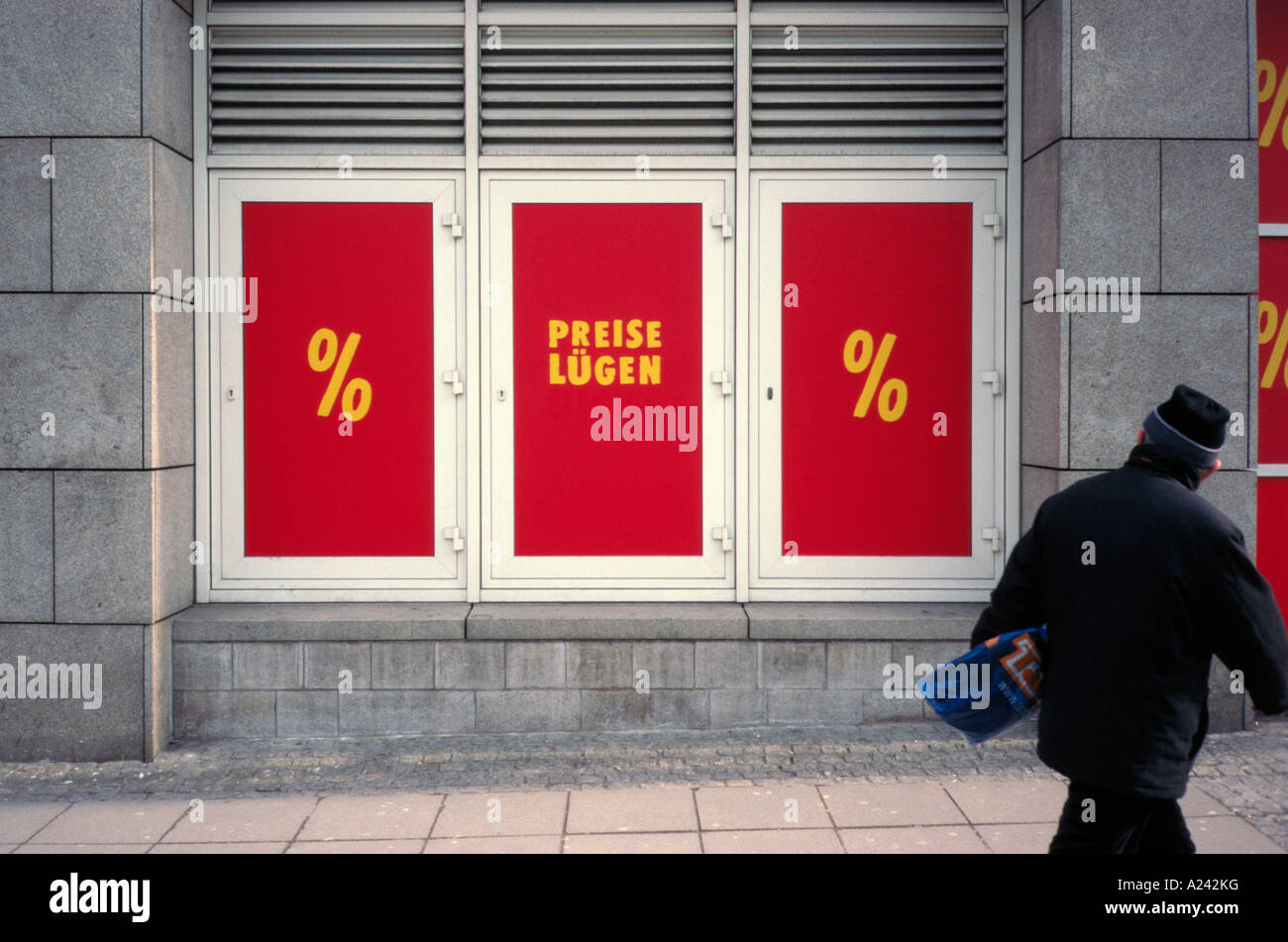 Prices don t lie was written in german on a shop window but the don t has been removed leaving Prices lie Stock Photo