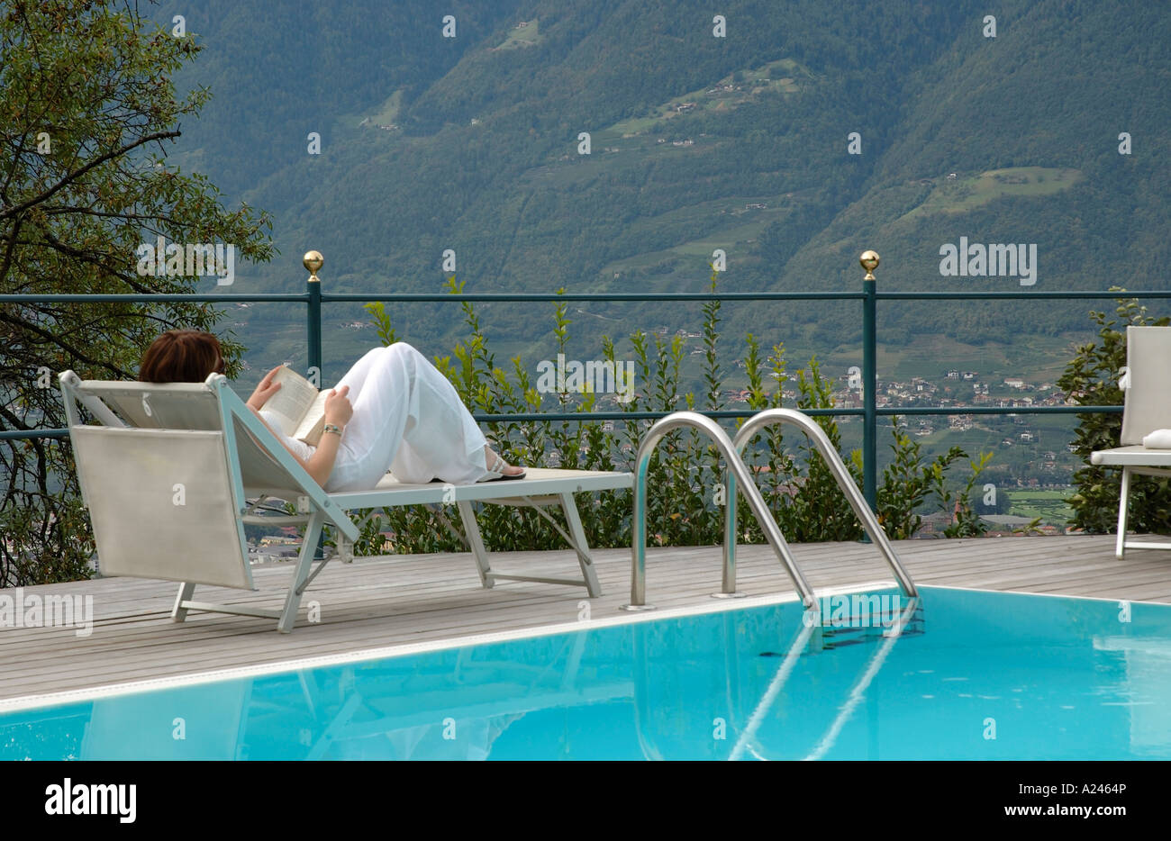 Woman parasol swimming pool hi-res stock photography and images - Alamy